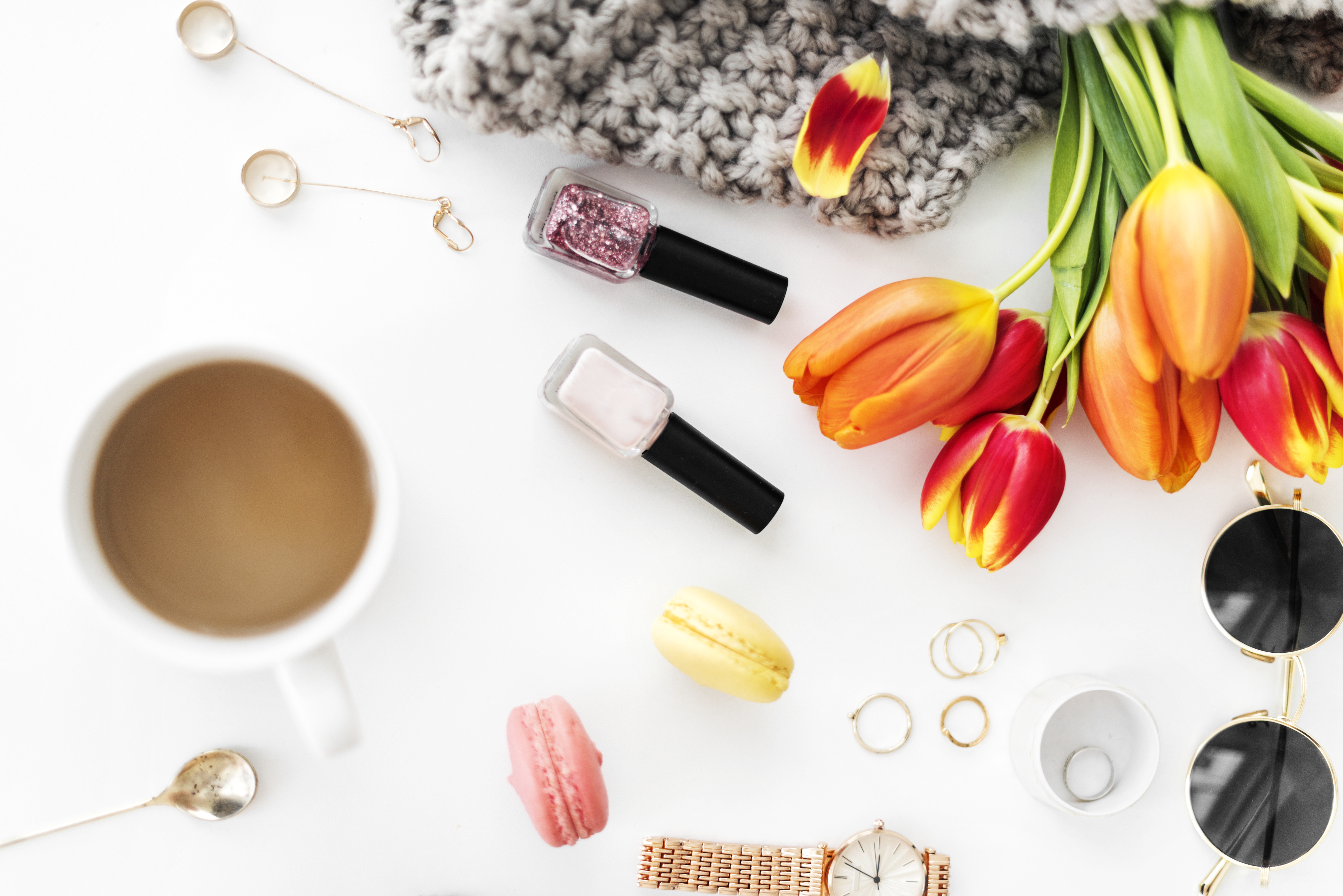 Flat lay of tulips, coffee, and makeup HD Wallpaper