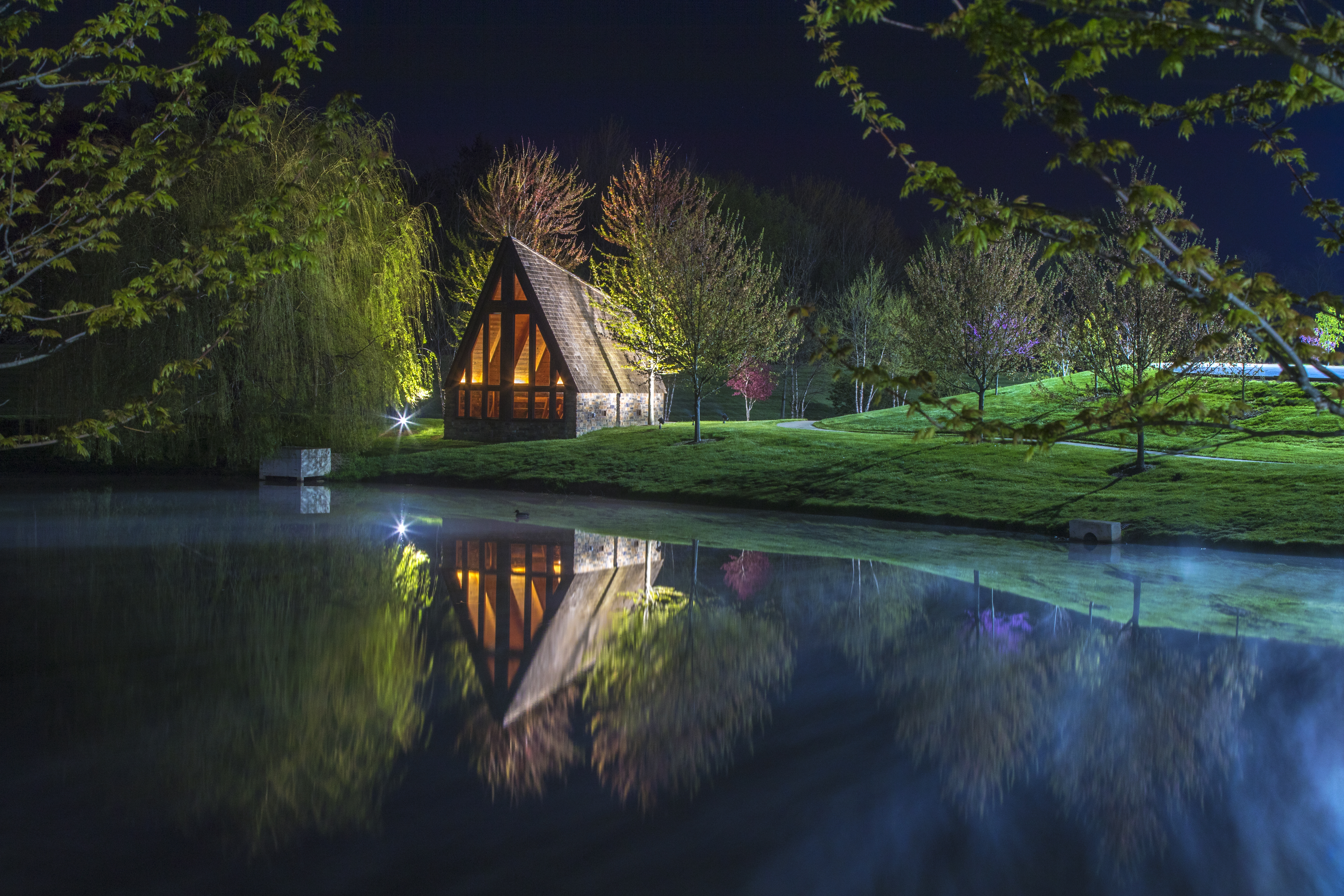 A-frame house reflected in a pond at night HD Wallpaper