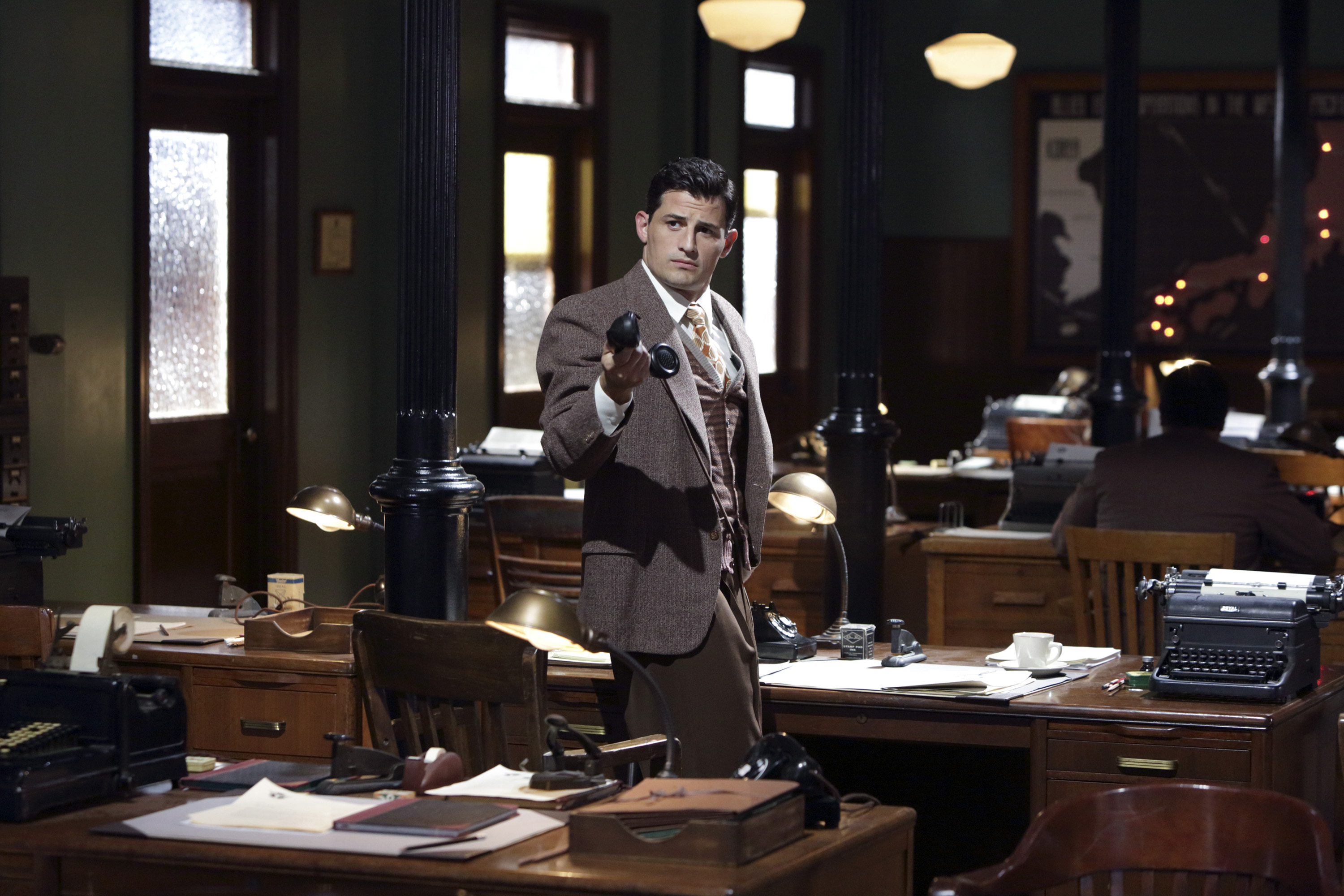 Daniel Sousa holding a phone in an office HD Wallpaper