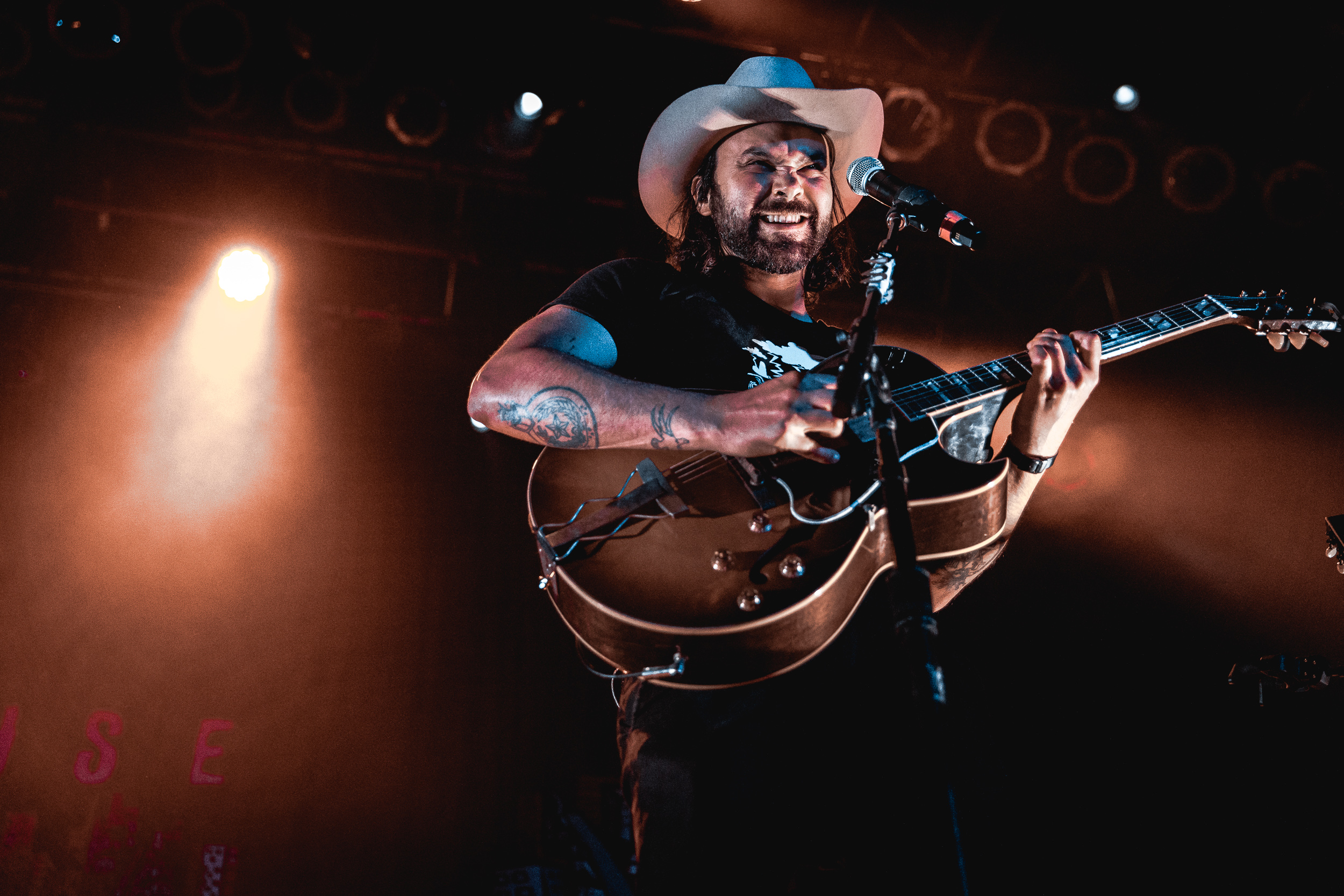 Shakey Graves performs on stage with a guitar HD Wallpaper