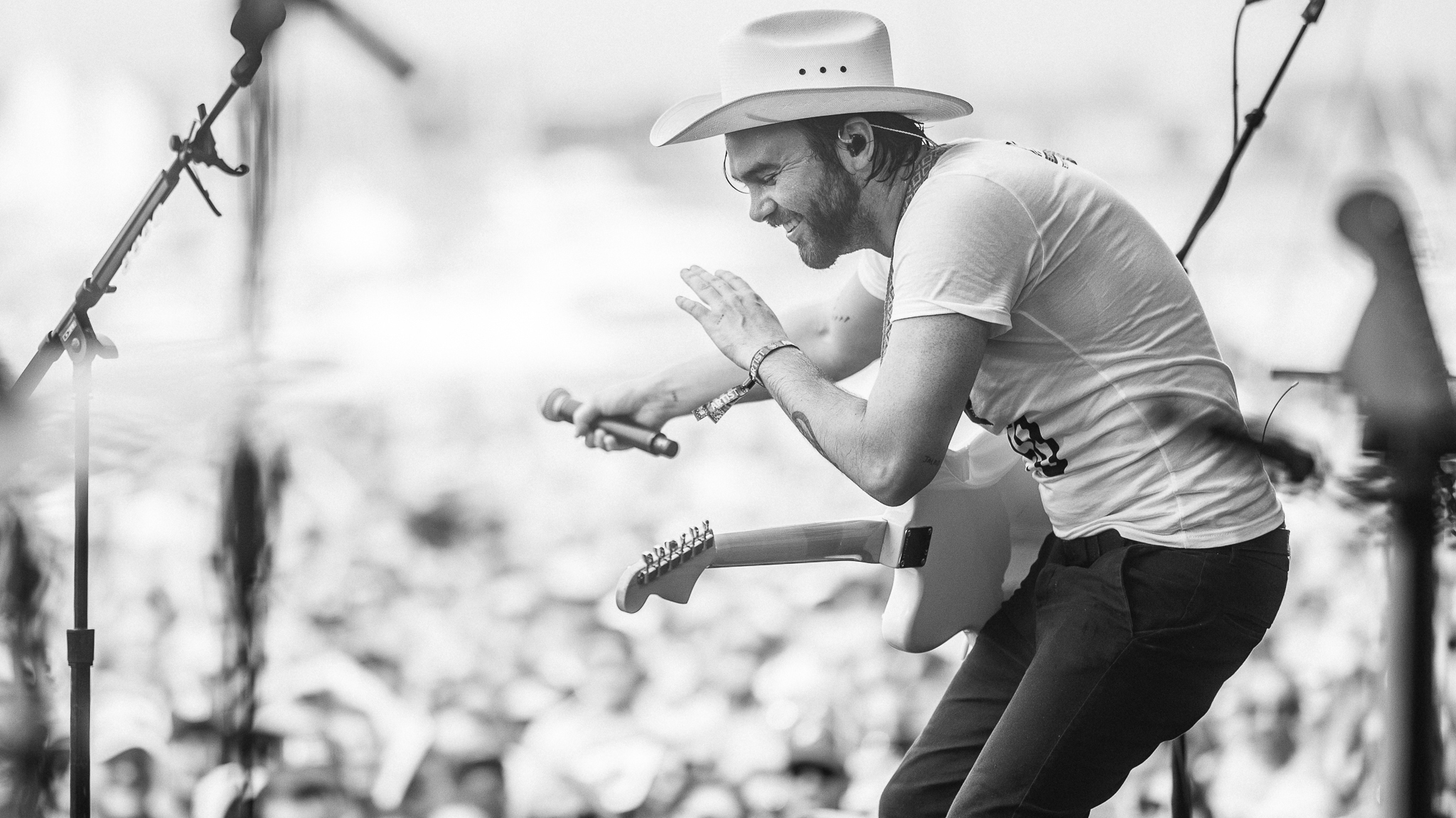 Shakey Graves performs on stage with a guitar HD Wallpaper