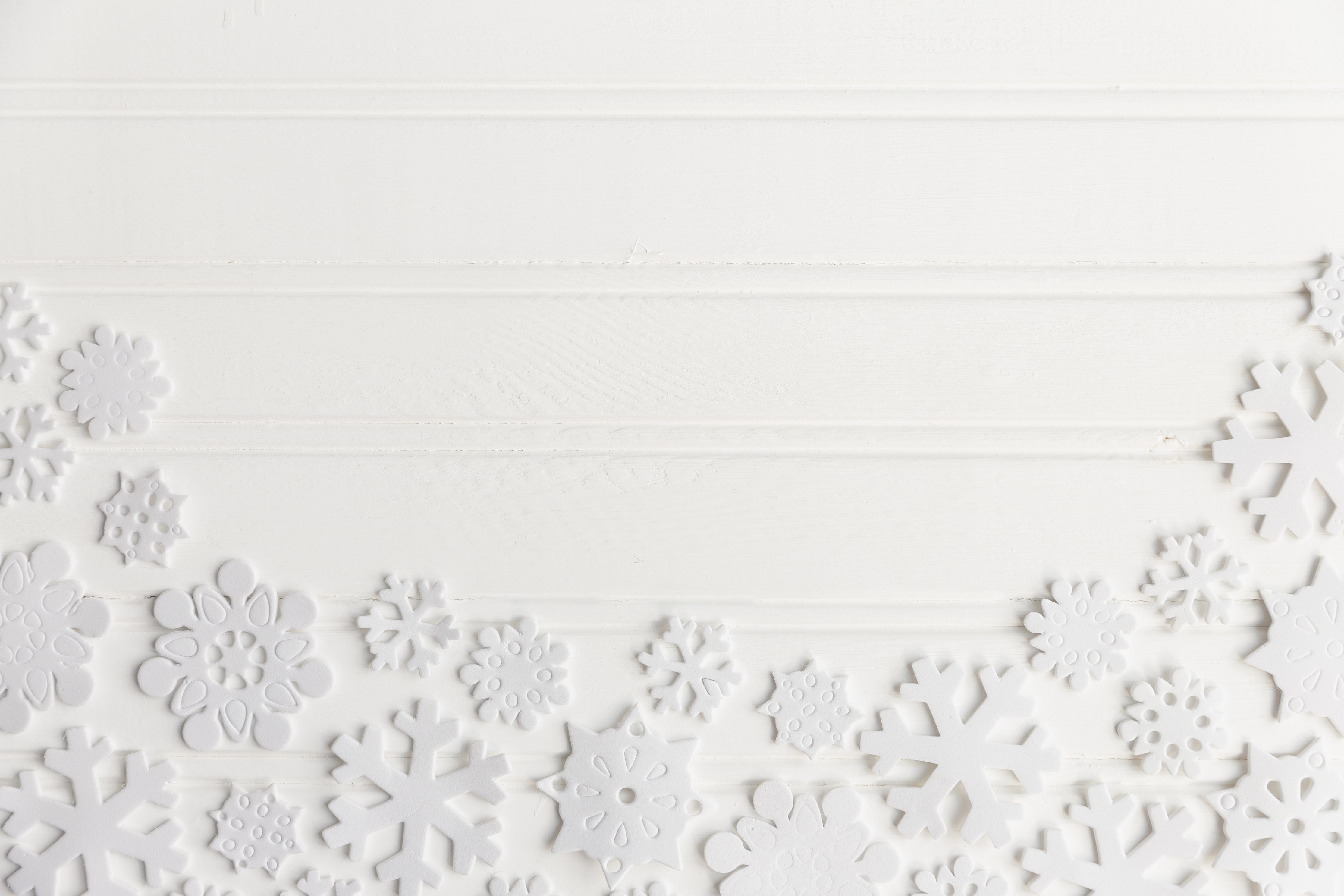 White snowflakes on a white wooden background HD Wallpaper