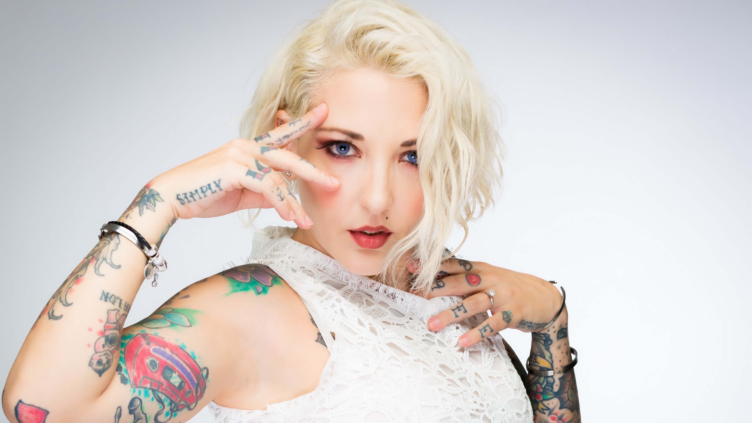 Blonde Woman with Colorful Tattoos and Blue Eyes HD Wallpaper