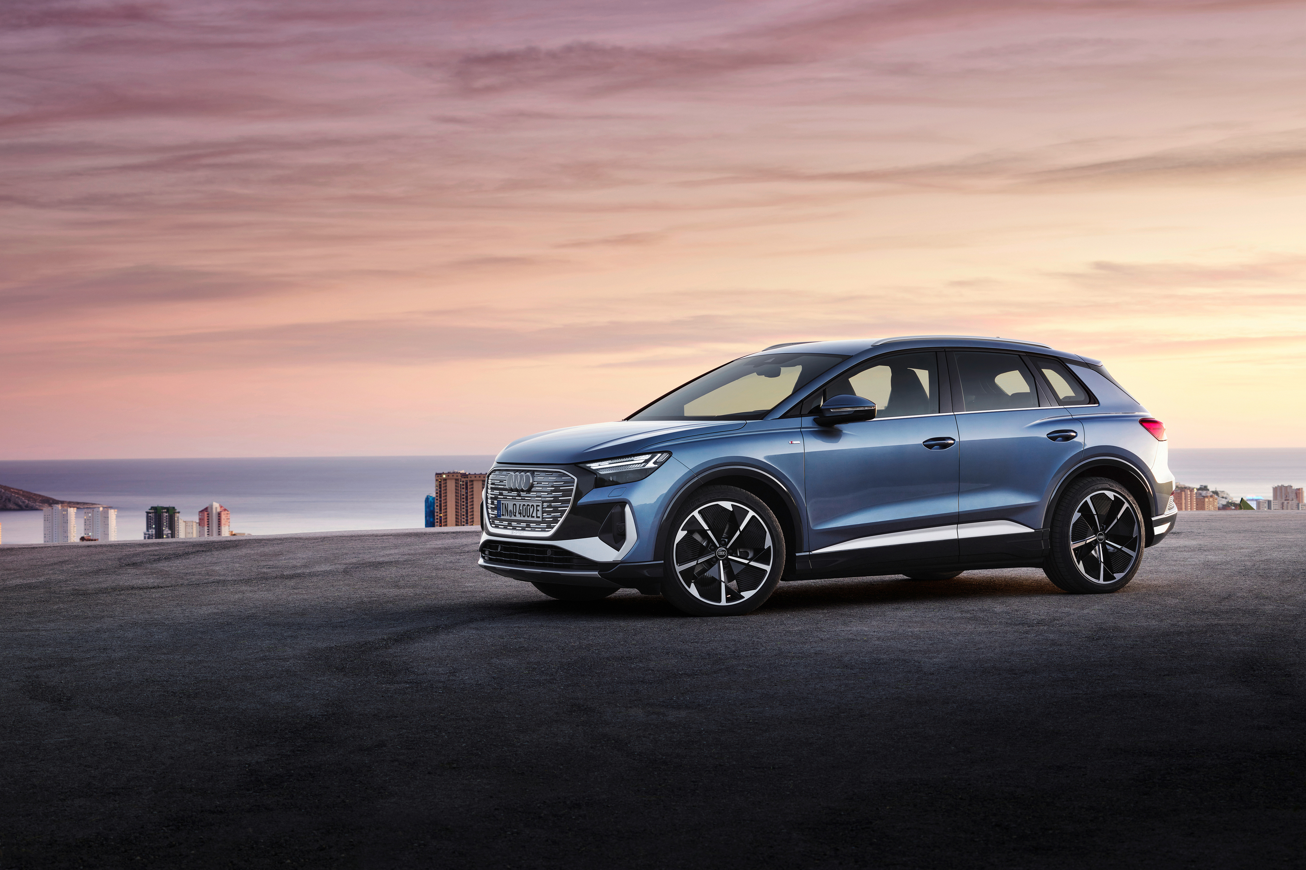 Blue Audi Q4 E-tron SUV parked by the sea HD Wallpaper