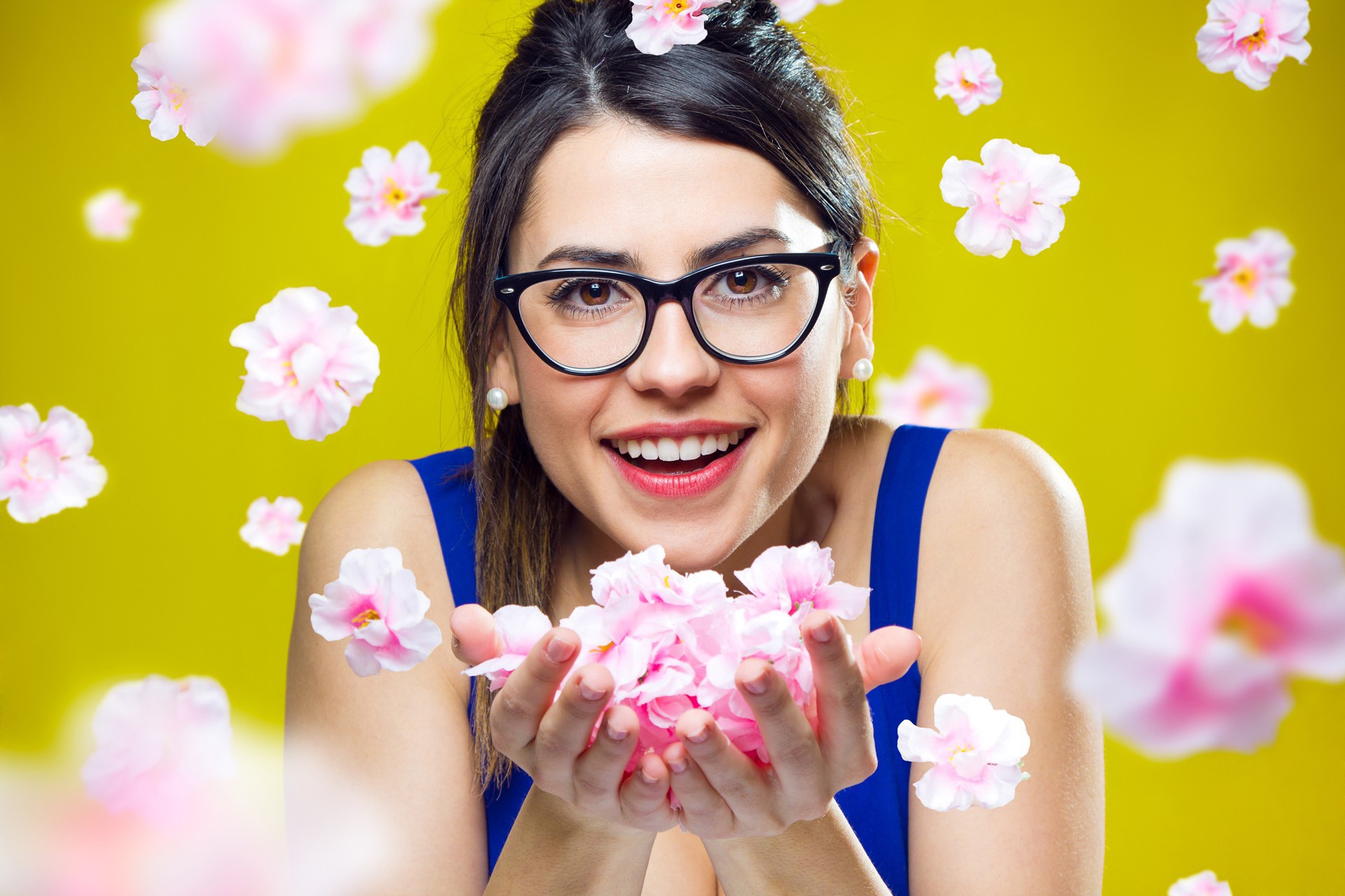 Woman with glasses holding pink flowers HD Wallpaper