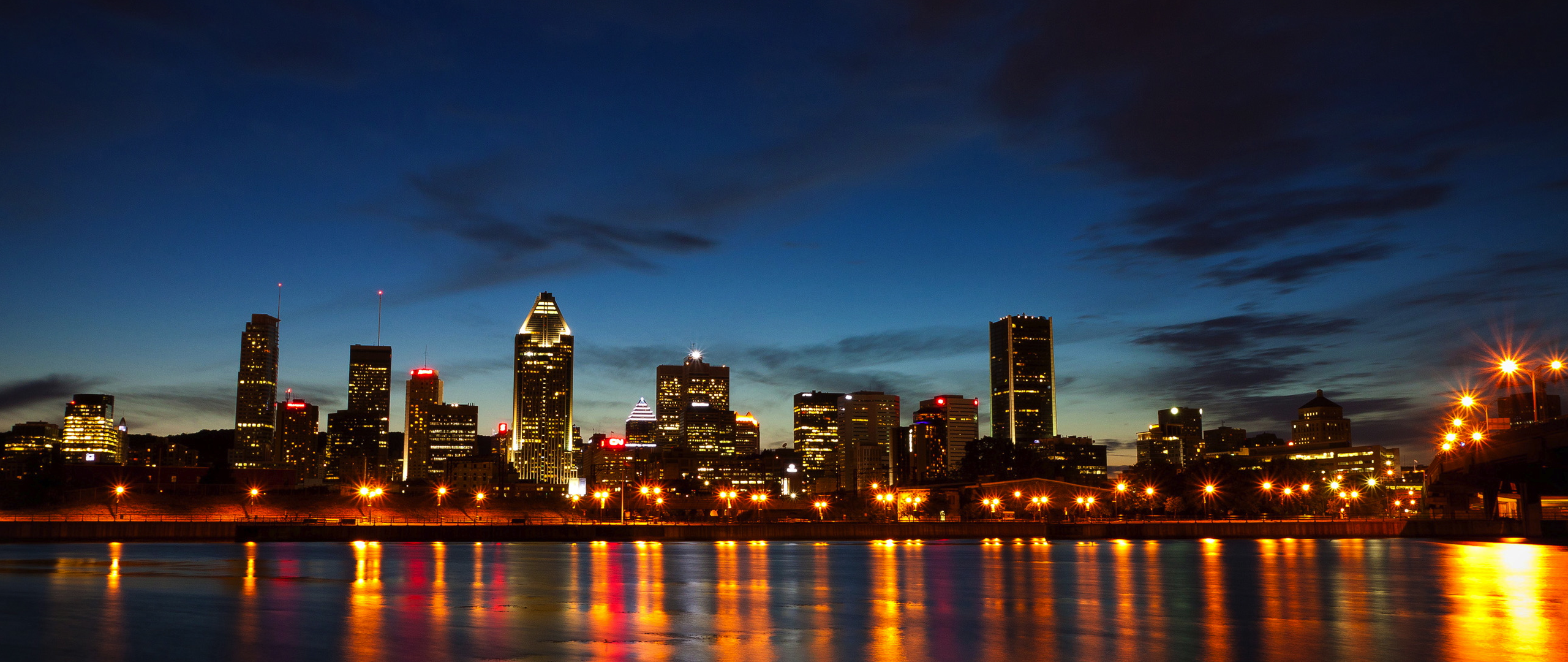 Montreal skyline at dusk reflected in the St. Lawrence River HD Wallpaper