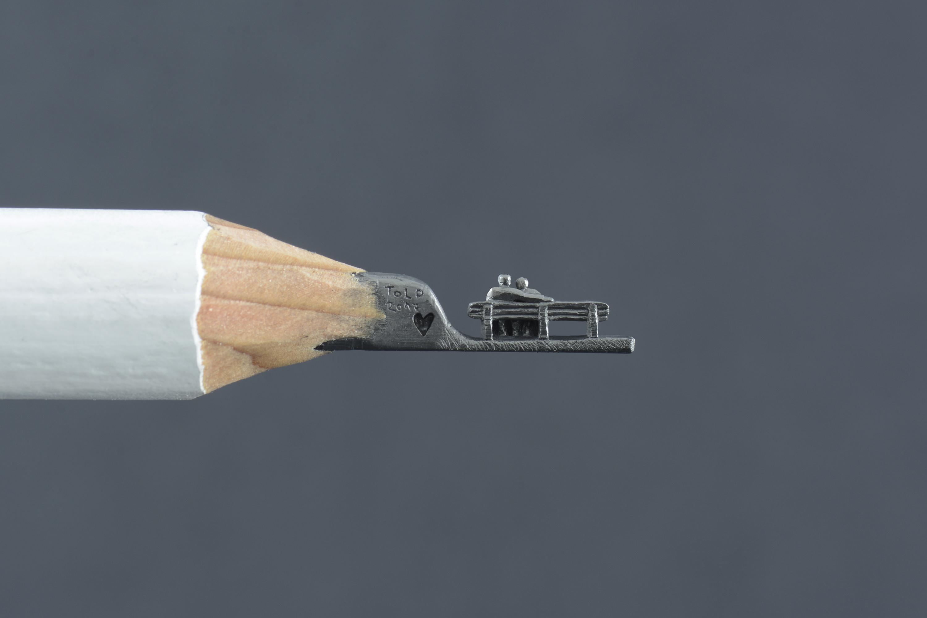 Tiny lovers bench carved on a pencil tip HD Wallpaper