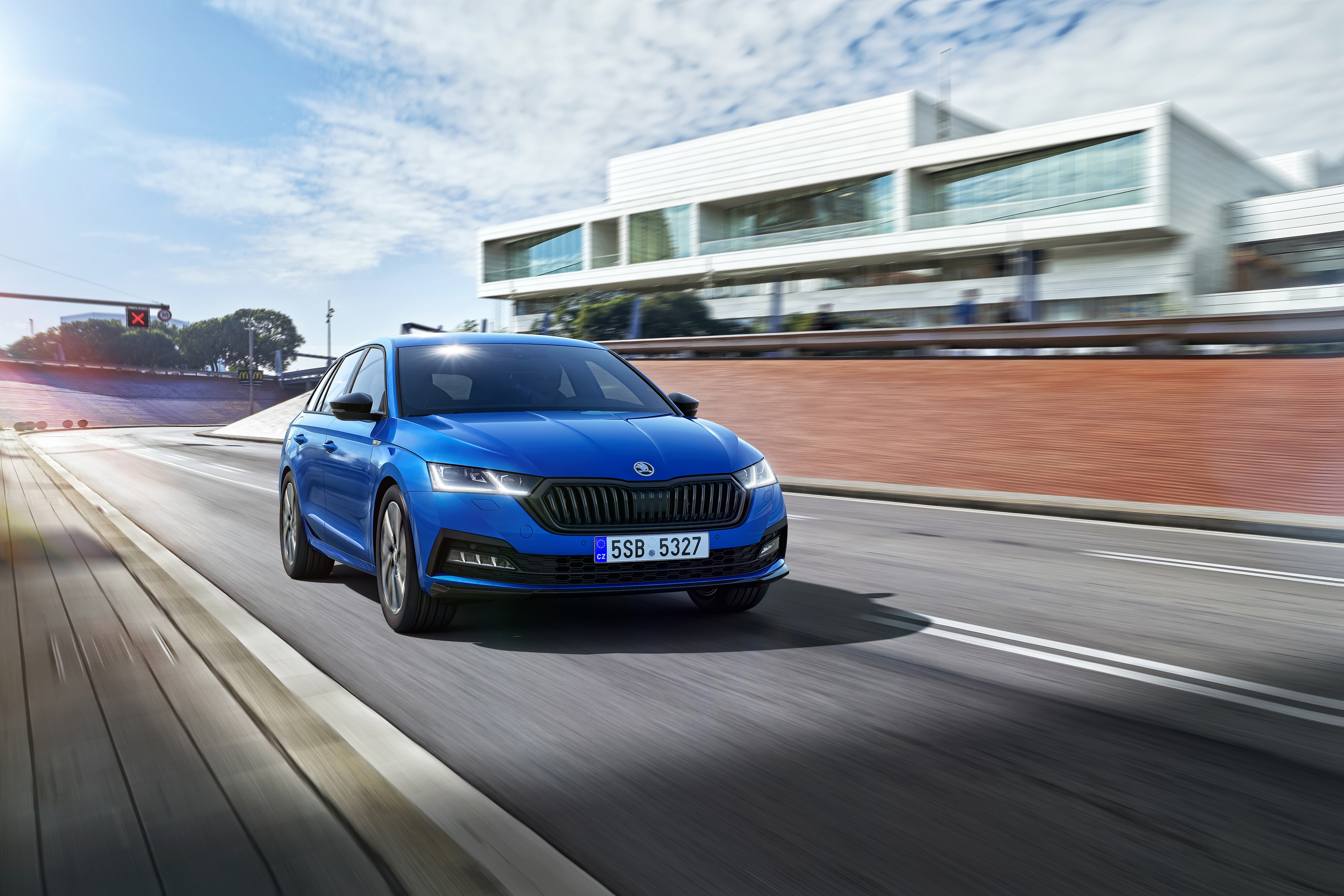 Blue Skoda Octavia 4K driving on a road HD Wallpaper