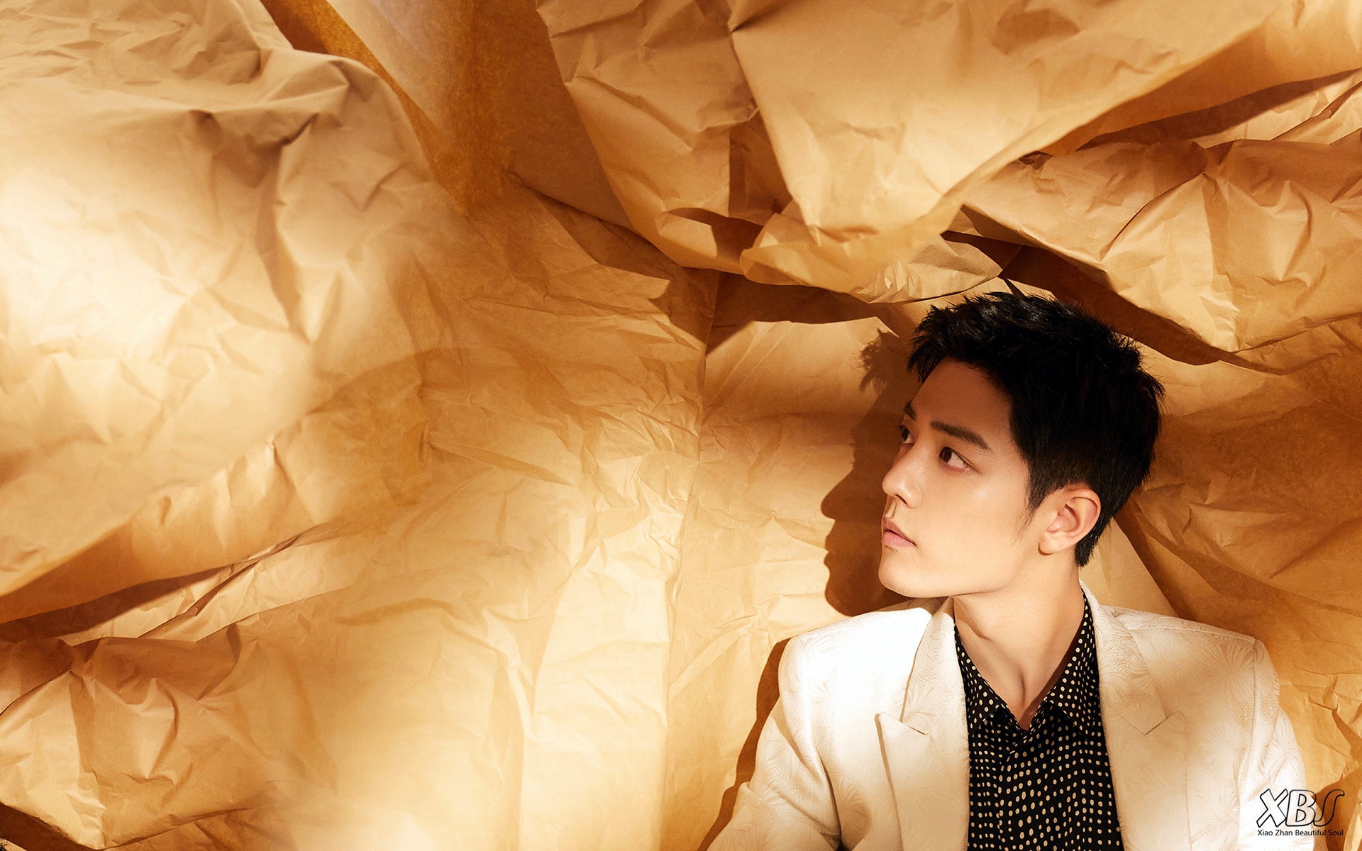 Xiao Zhan in a white suit against crumpled paper HD Wallpaper