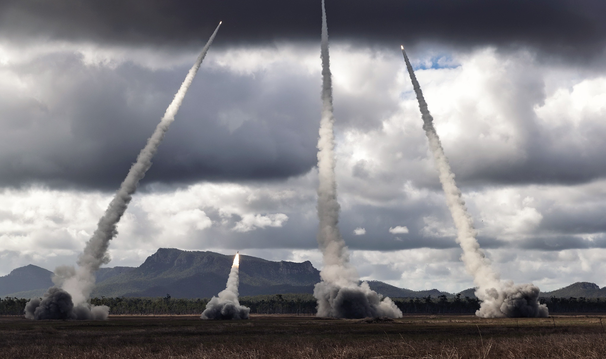Multiple missiles launch into a cloudy sky HD Wallpaper