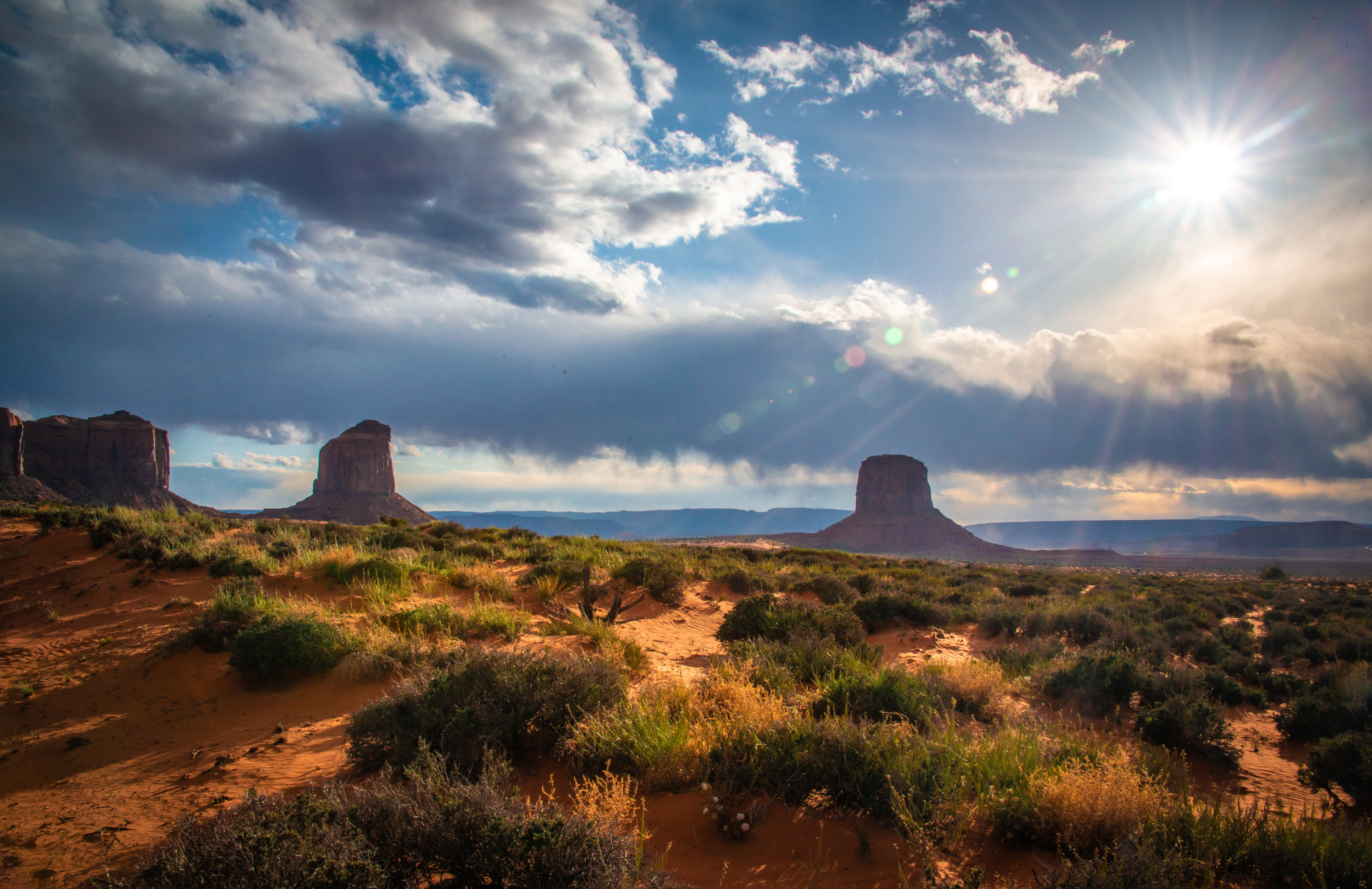 Monument Valley Desert Landscape with Sun and Clouds 4K HD Wallpaper
