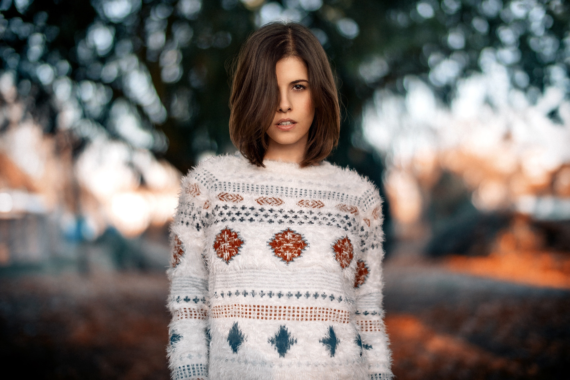 Woman in a patterned sweater outdoors HD Wallpaper