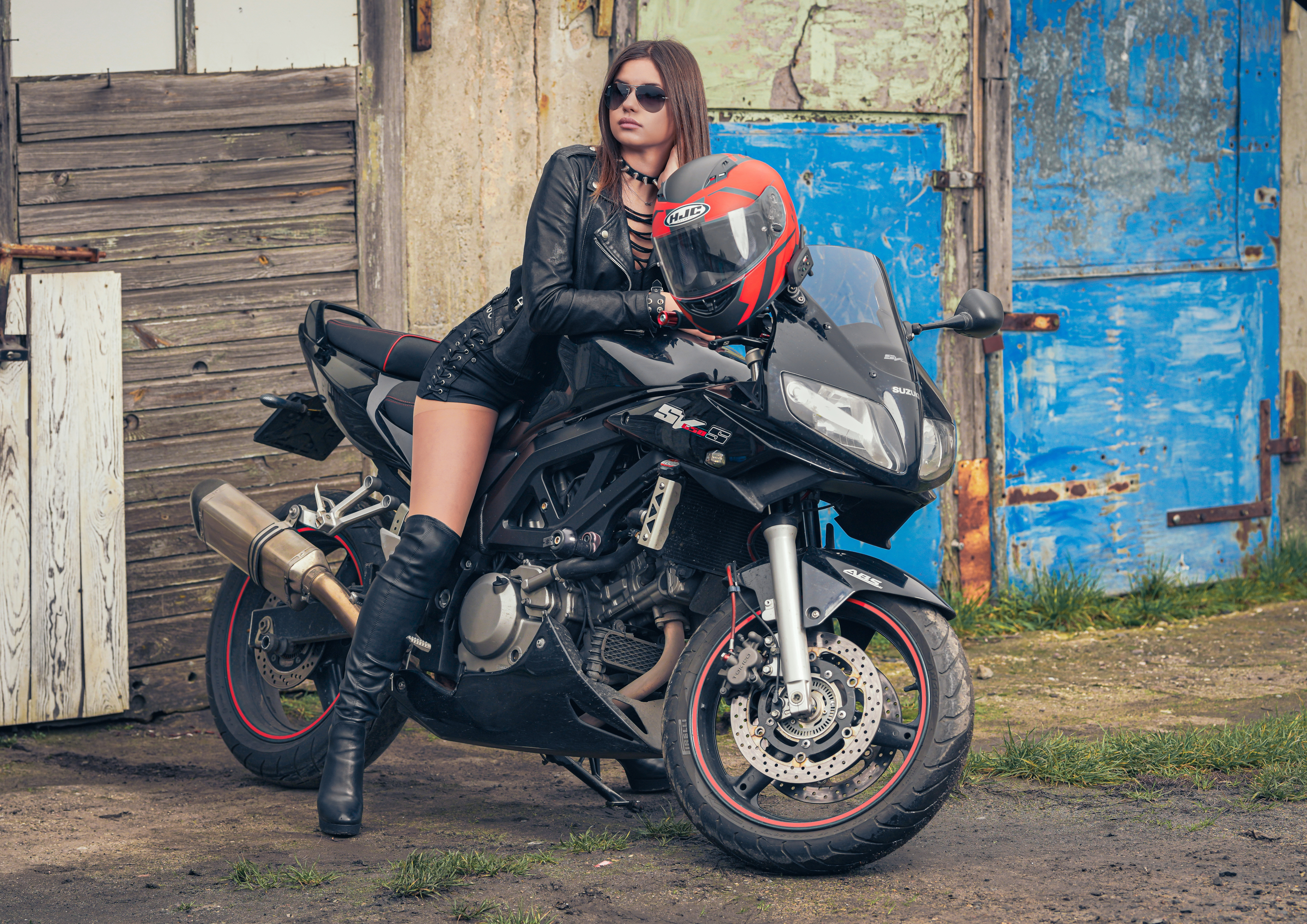 Woman in leather sitting on a Suzuki SV650S motorcycle HD Wallpaper