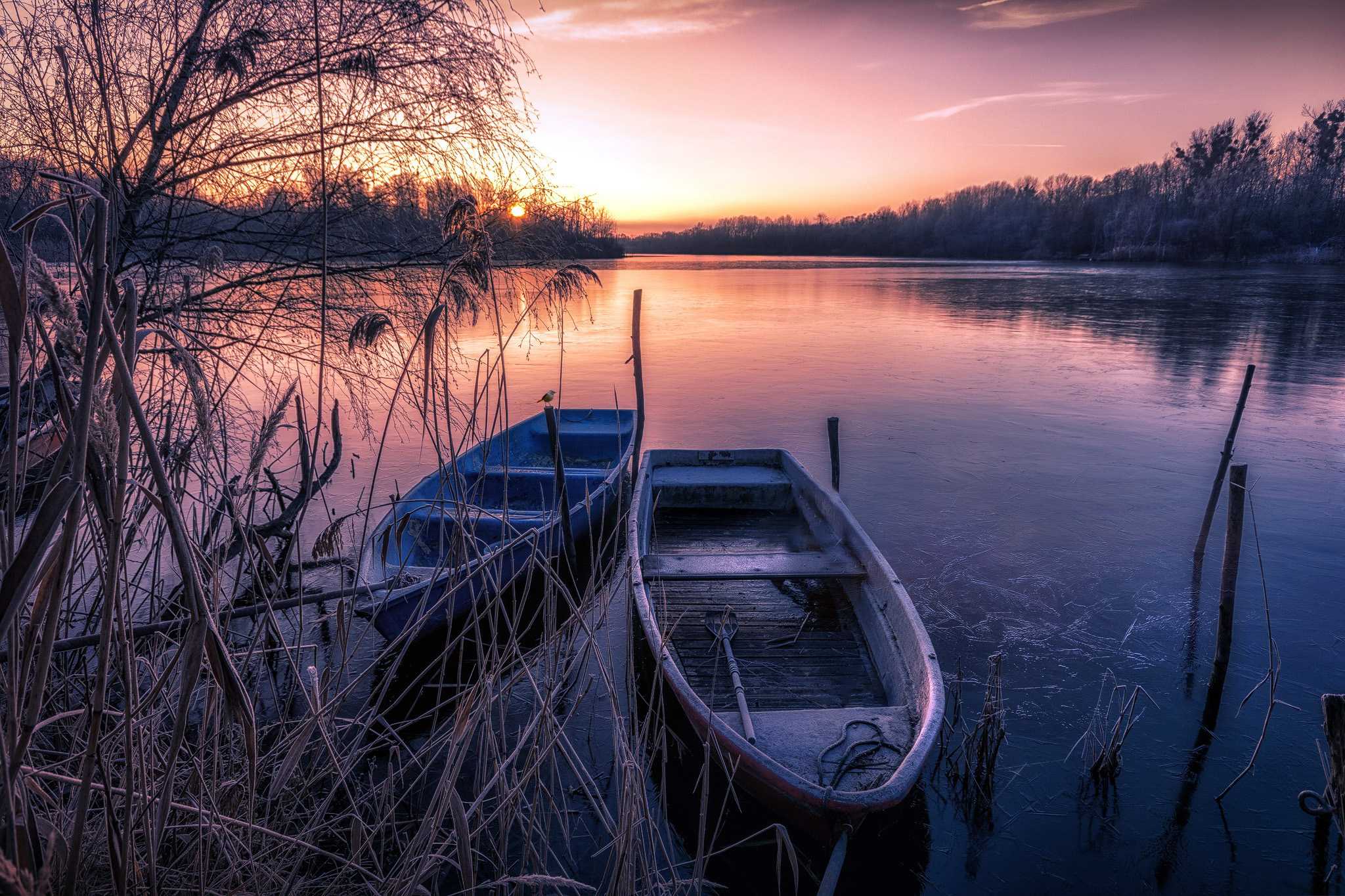 Two boats on a frozen lake at sunset HD Wallpaper