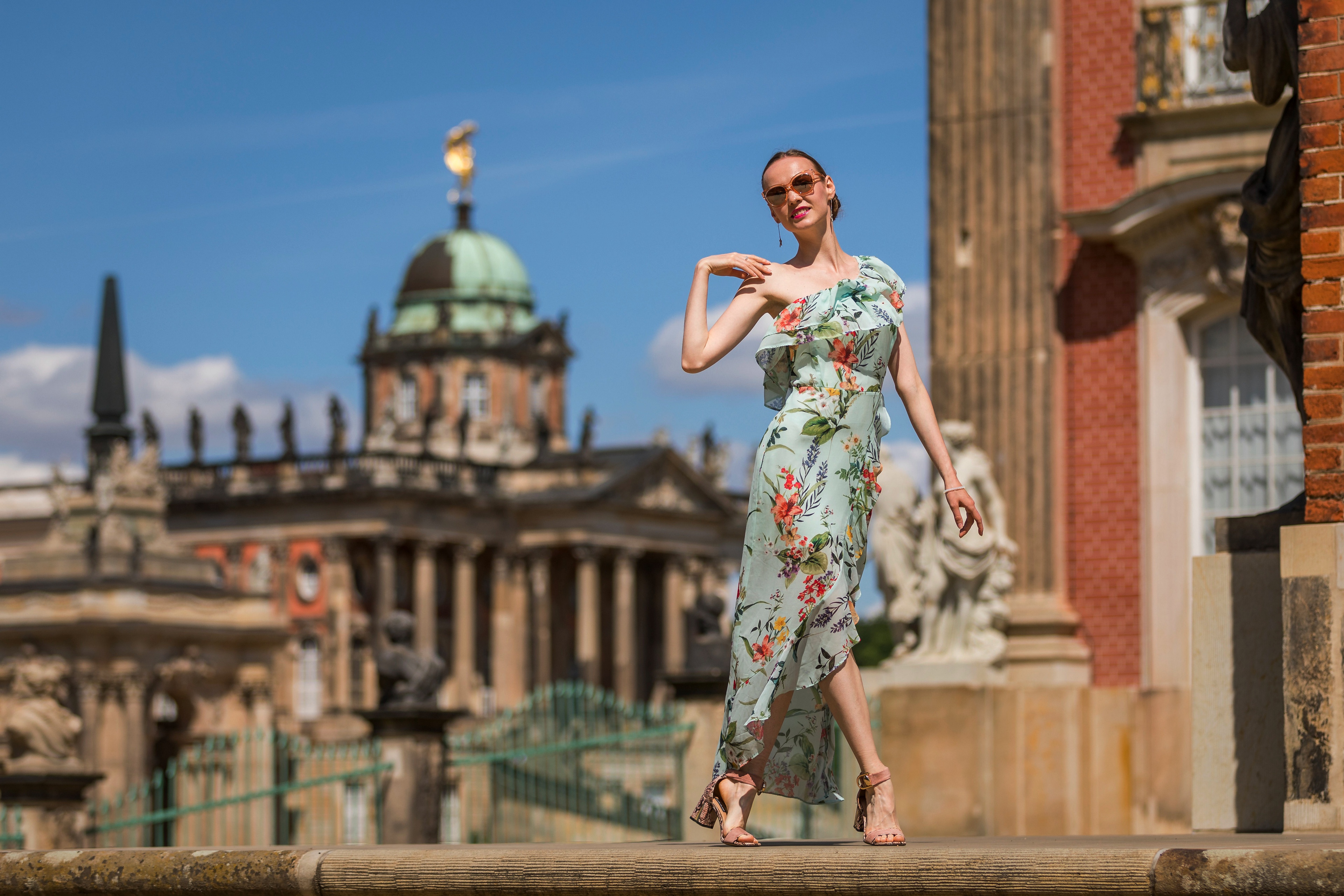 Woman in floral dress in front of palace HD Wallpaper