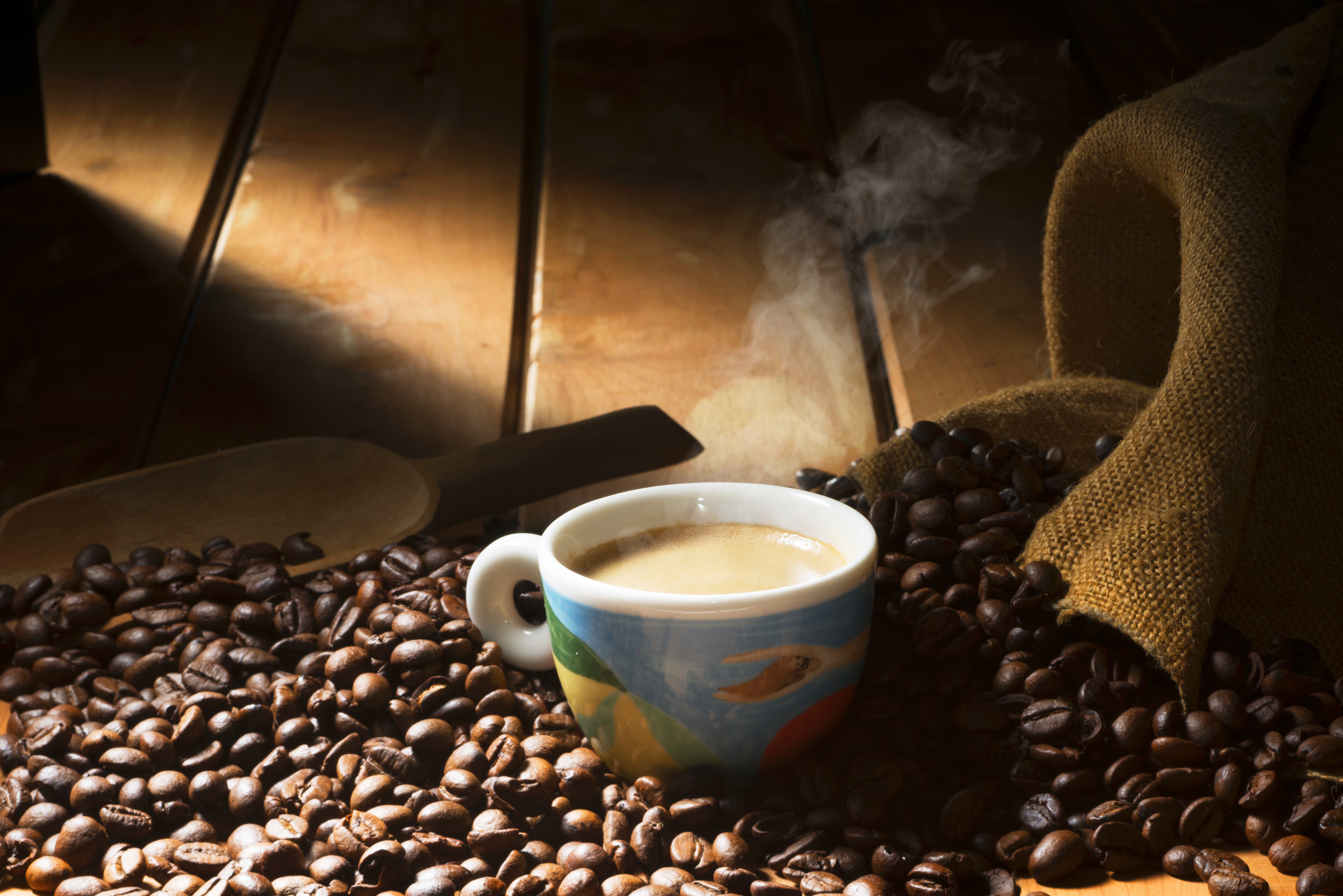 Coffee cup with steam and coffee beans HD Wallpaper