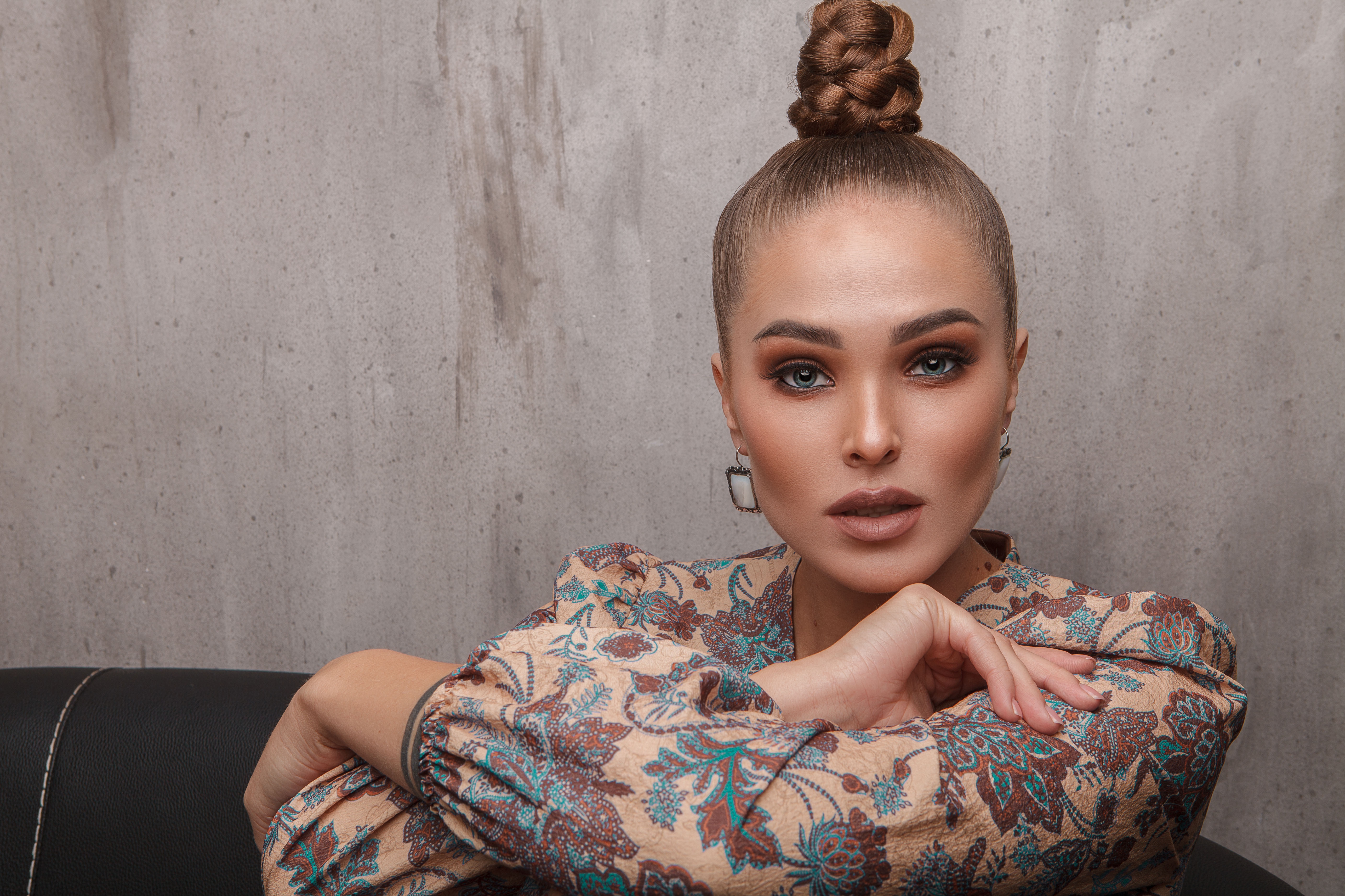 Woman with blue eyes and braided bun HD Wallpaper