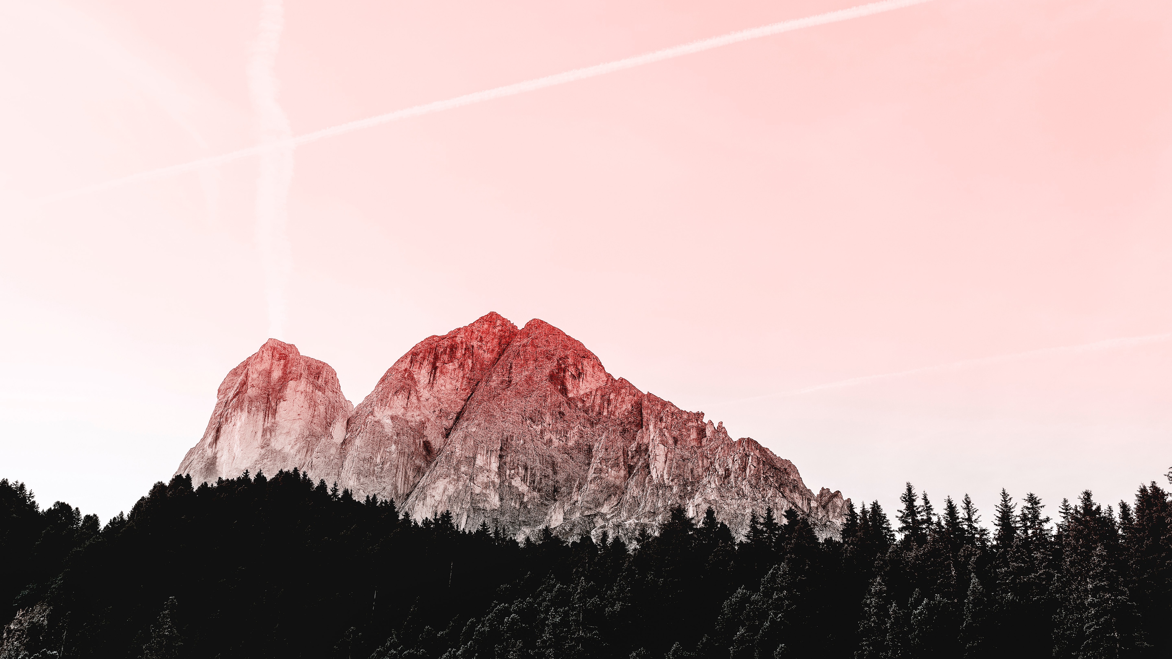 Mountain peaks above a dark forest with pink sky HD Wallpaper