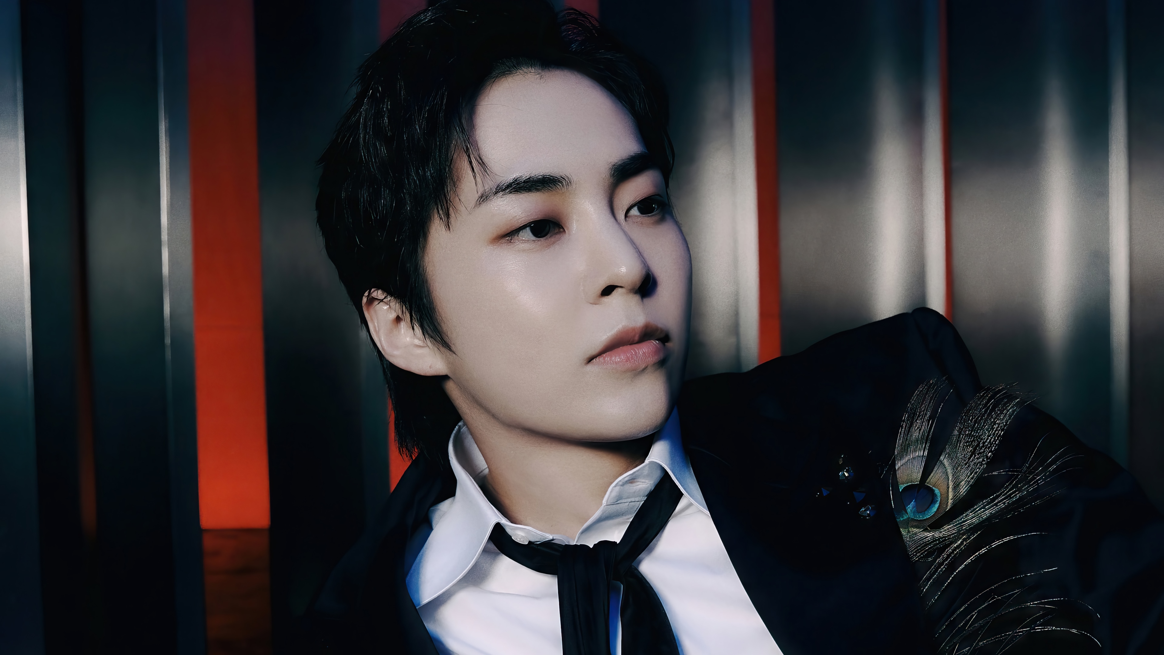 Xiumin in a black suit with peacock feather detail HD Wallpaper