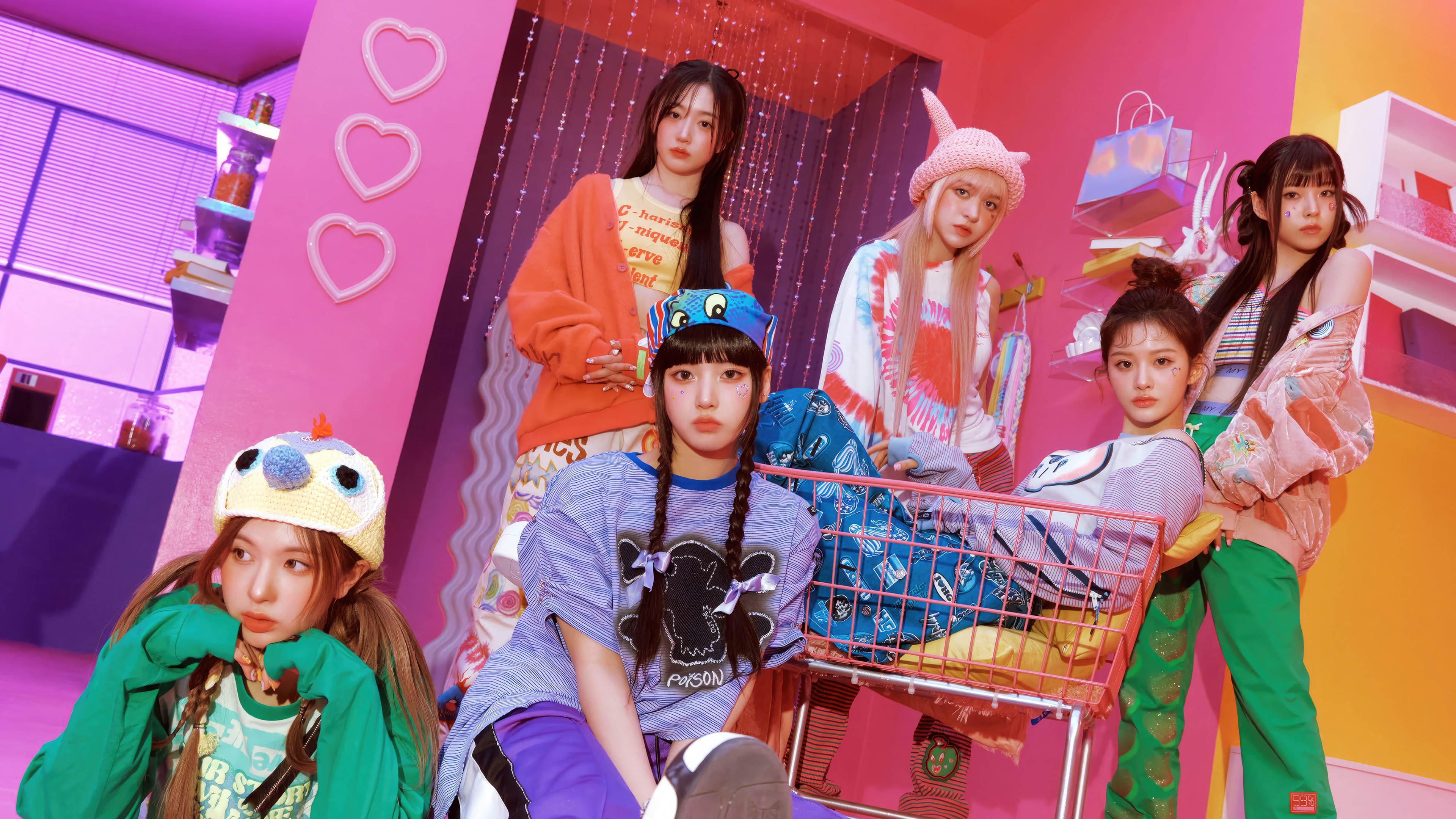 NMIXX members posing in a colorful room HD Wallpaper