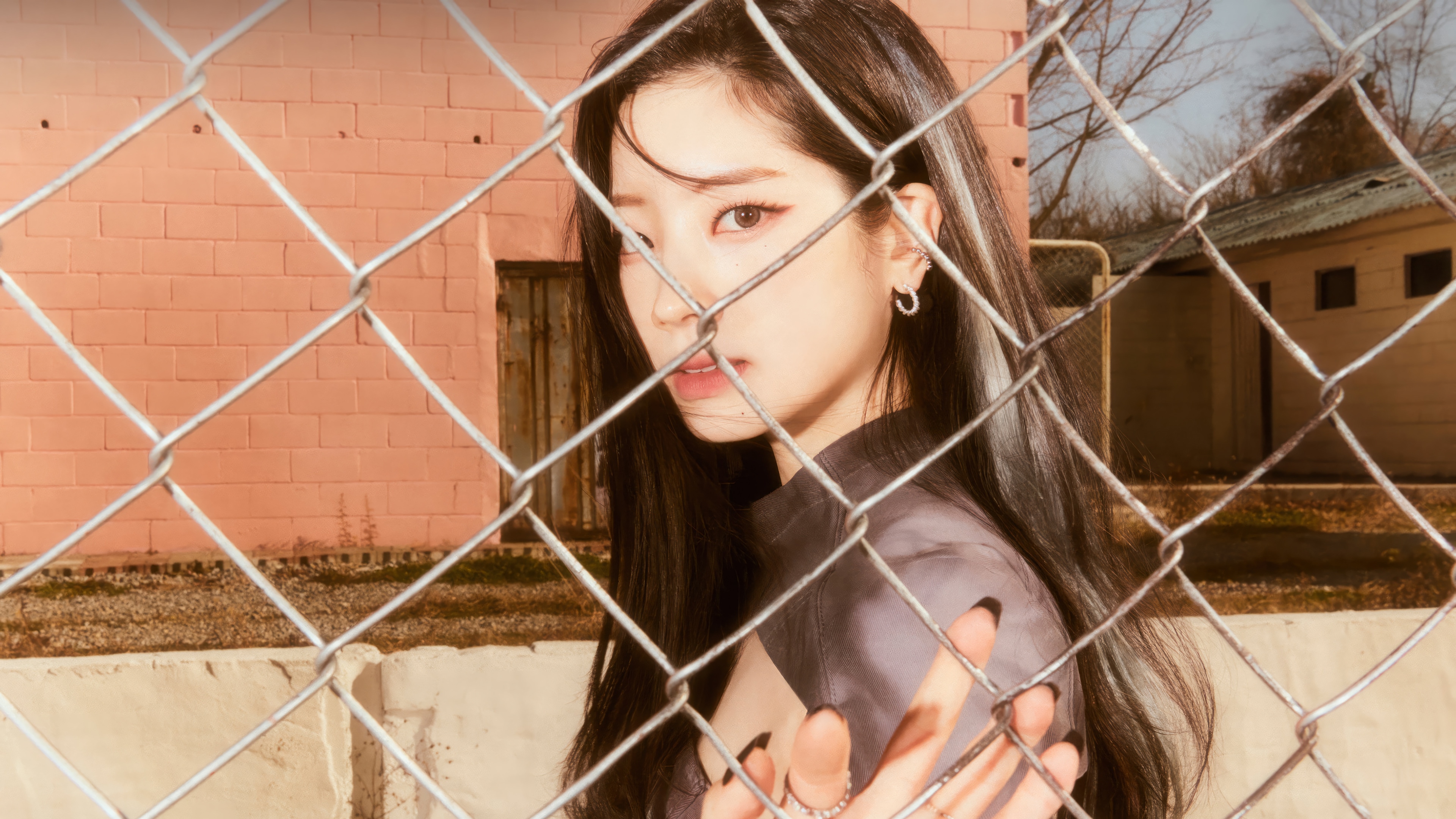 Dahyun from TWICE behind a chain-link fence HD Wallpaper