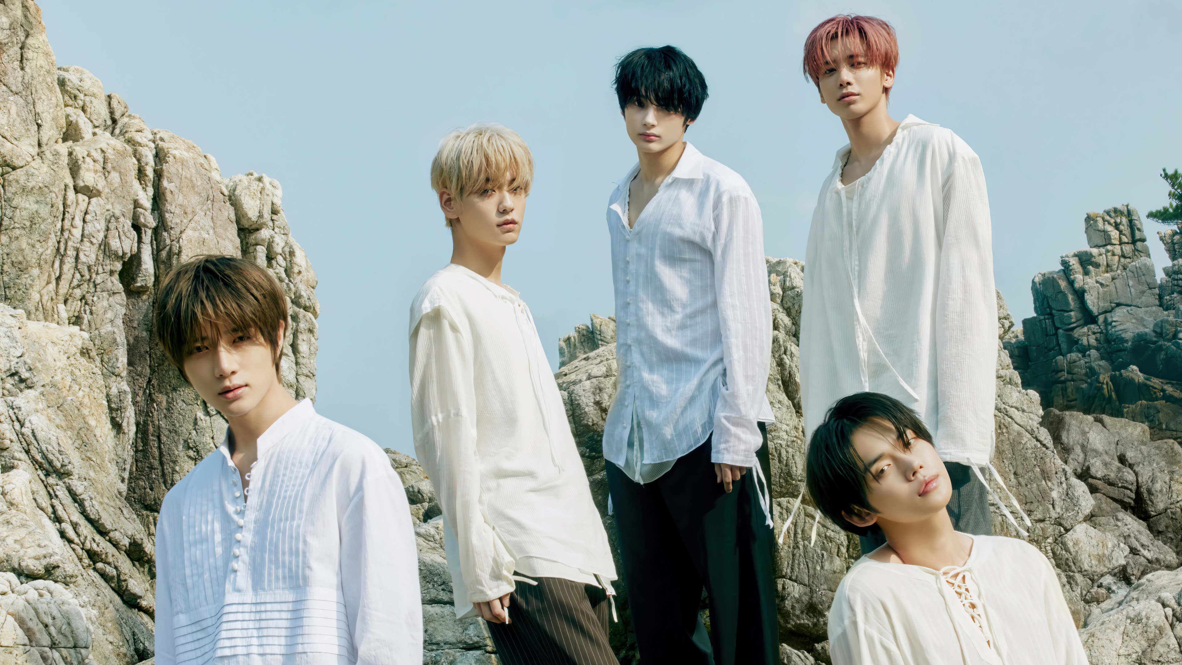 TXT members posing on rocky terrain HD Wallpaper