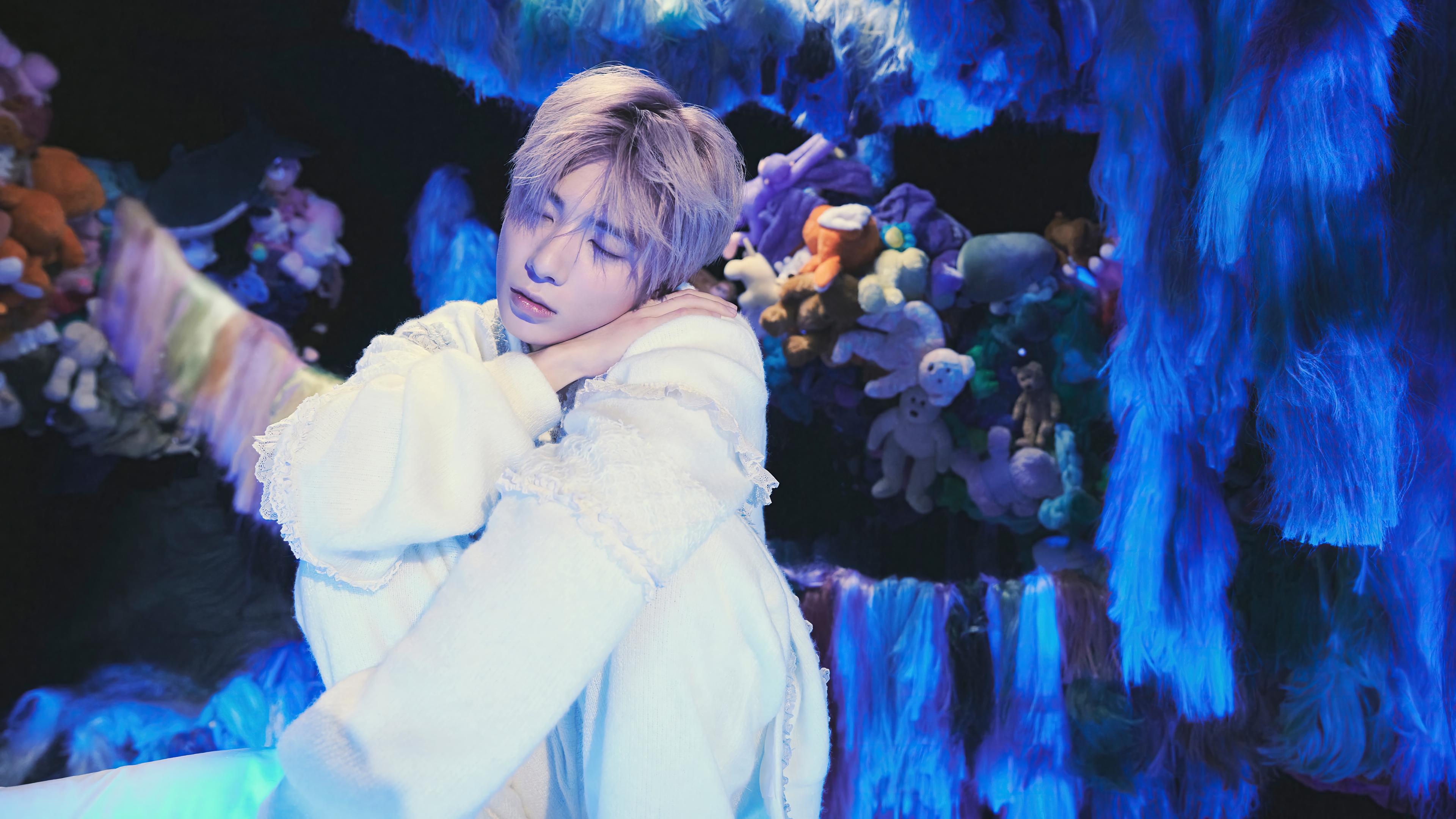 Taehyun from TXT in a surreal, plush-filled environment HD Wallpaper