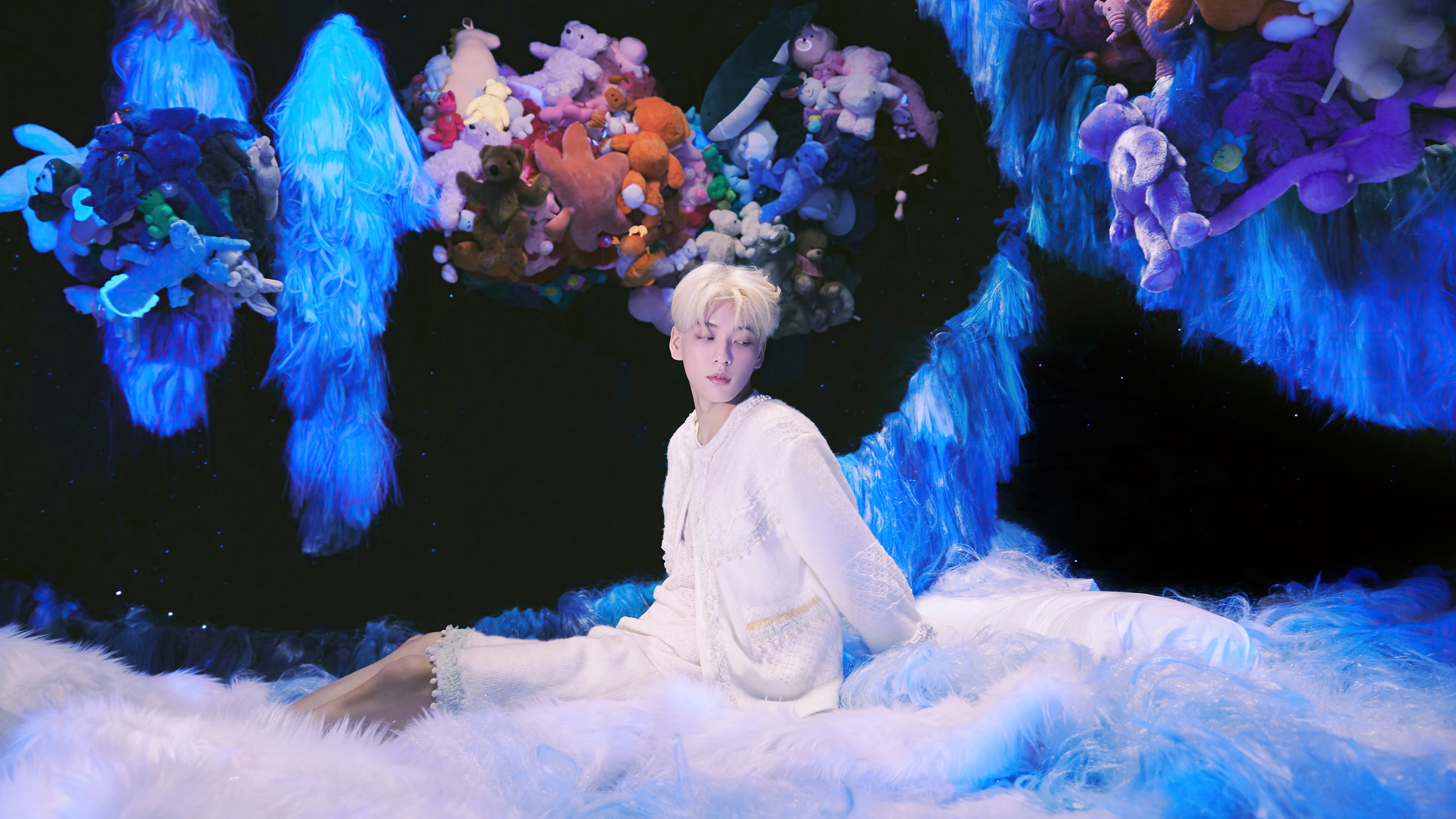 Soobin of TXT in a surreal, plush-filled environment HD Wallpaper