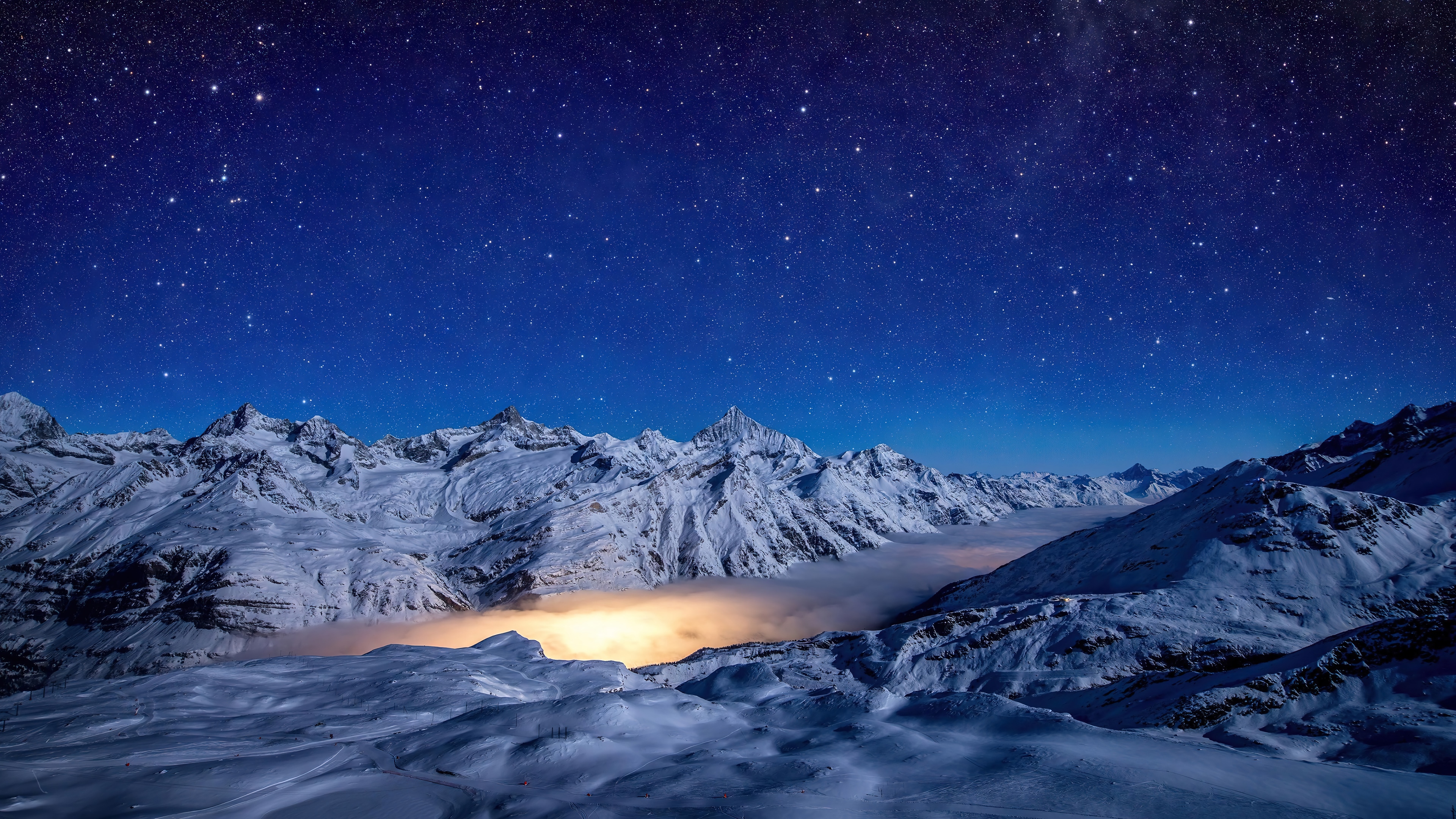 Snowy Mountains Under a Starry Night Sky 4K HD Wallpaper
