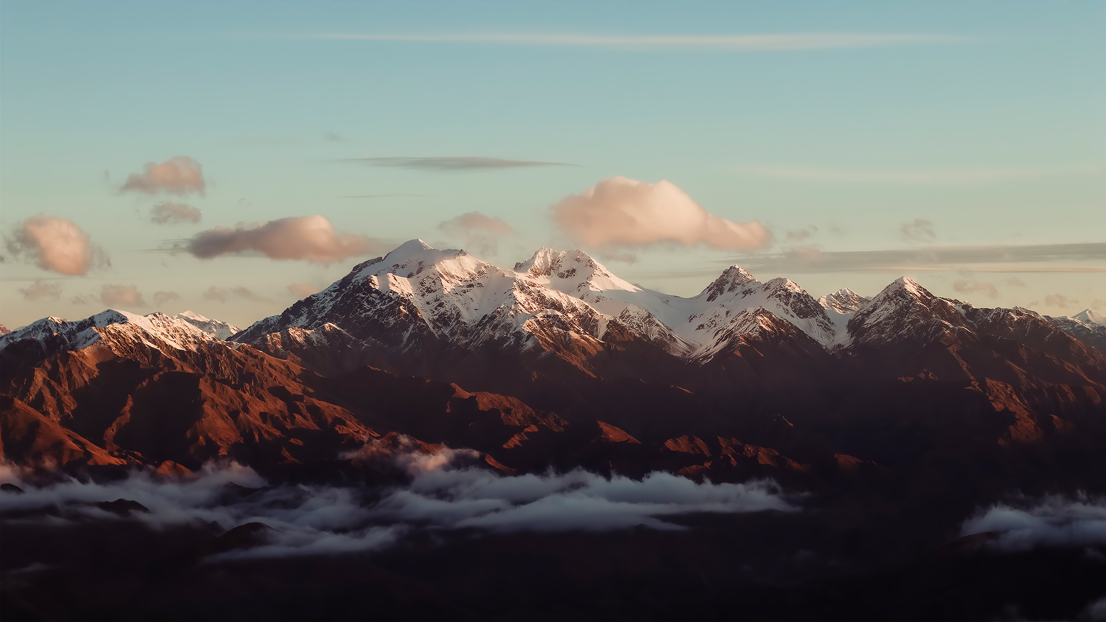 Snow-capped mountains at sunset with clouds HD Wallpaper