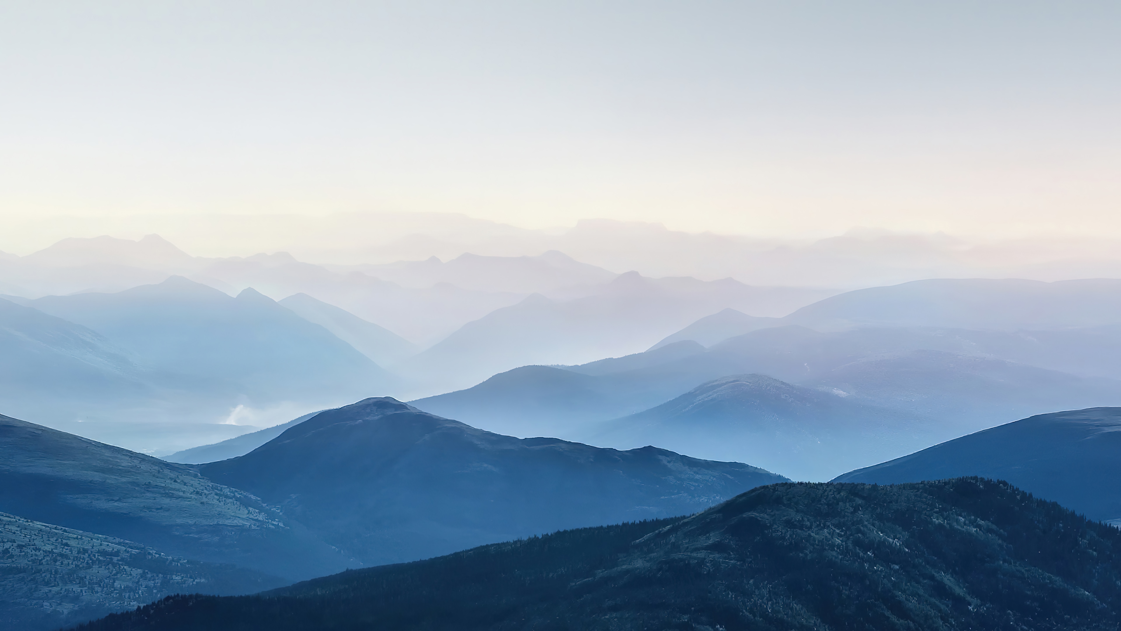 Mountain range shrouded in fog HD Wallpaper