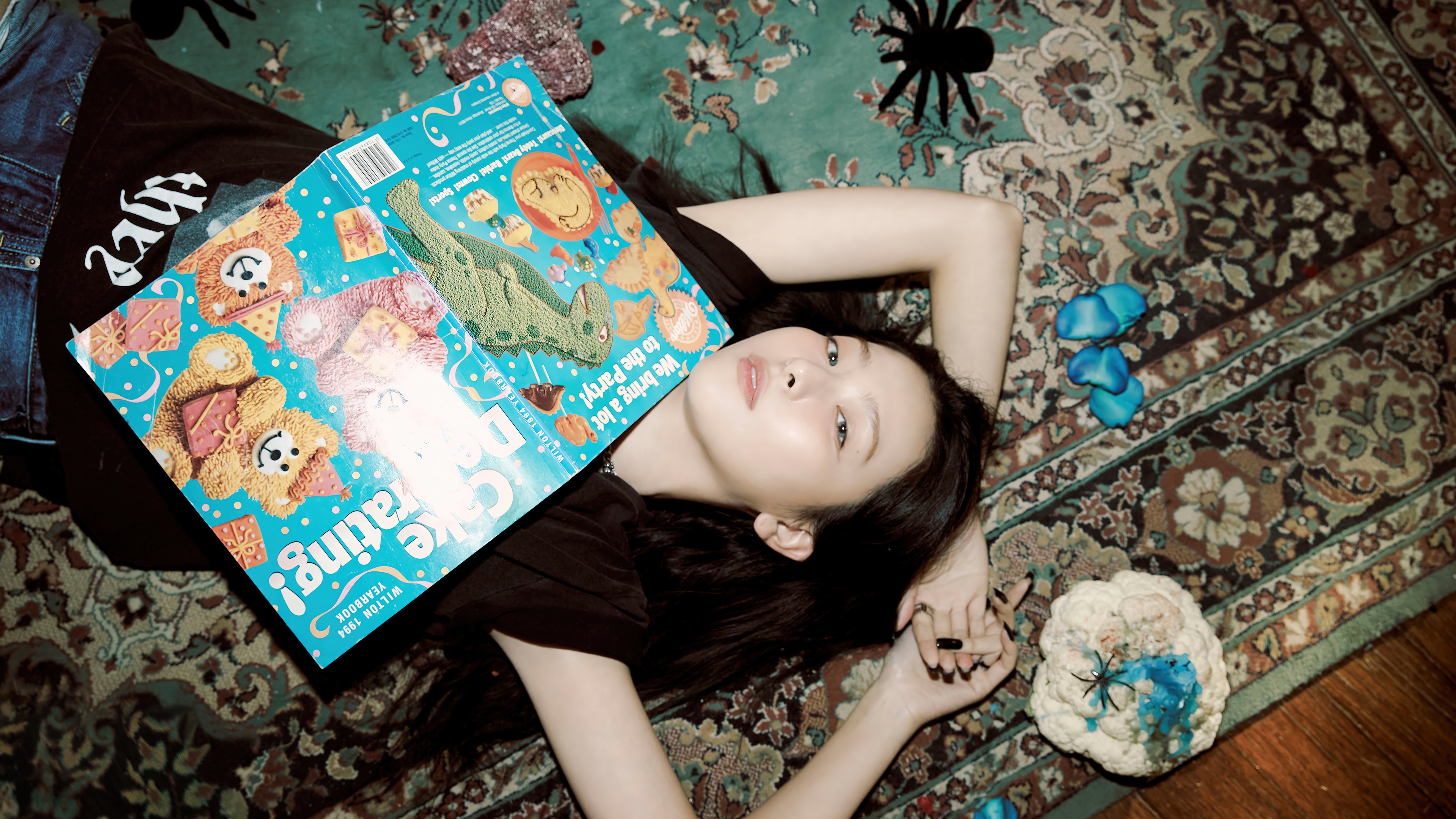 Seulgi lying on a rug with a book HD Wallpaper