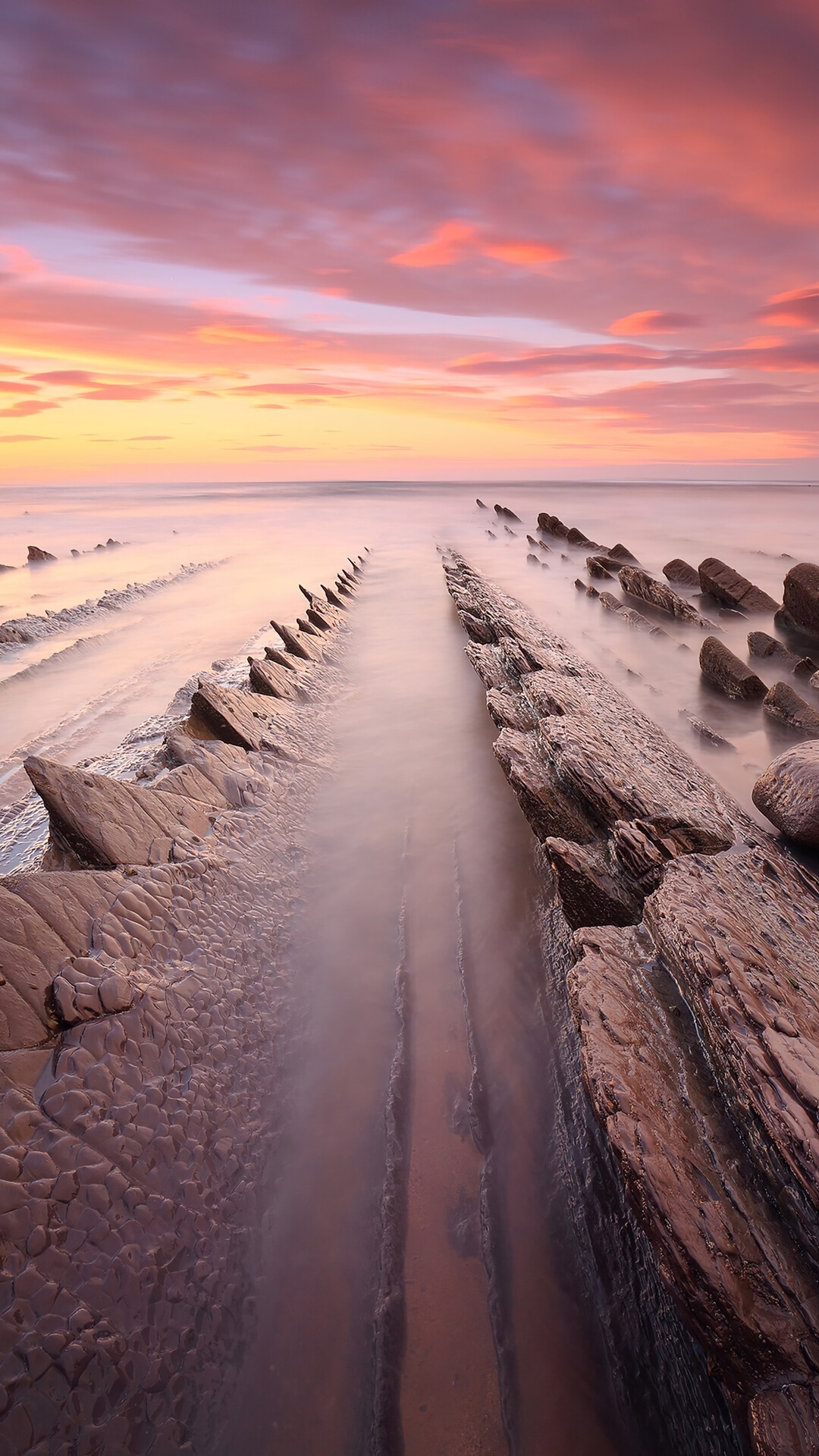 Sunset over rocky beach with misty water HD Phone Wallpaper