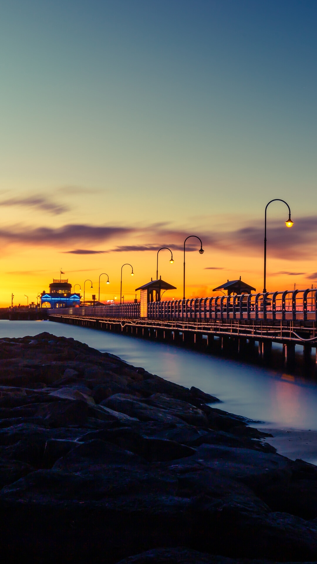 Sunset over a pier with streetlights and ocean HD Phone Wallpaper