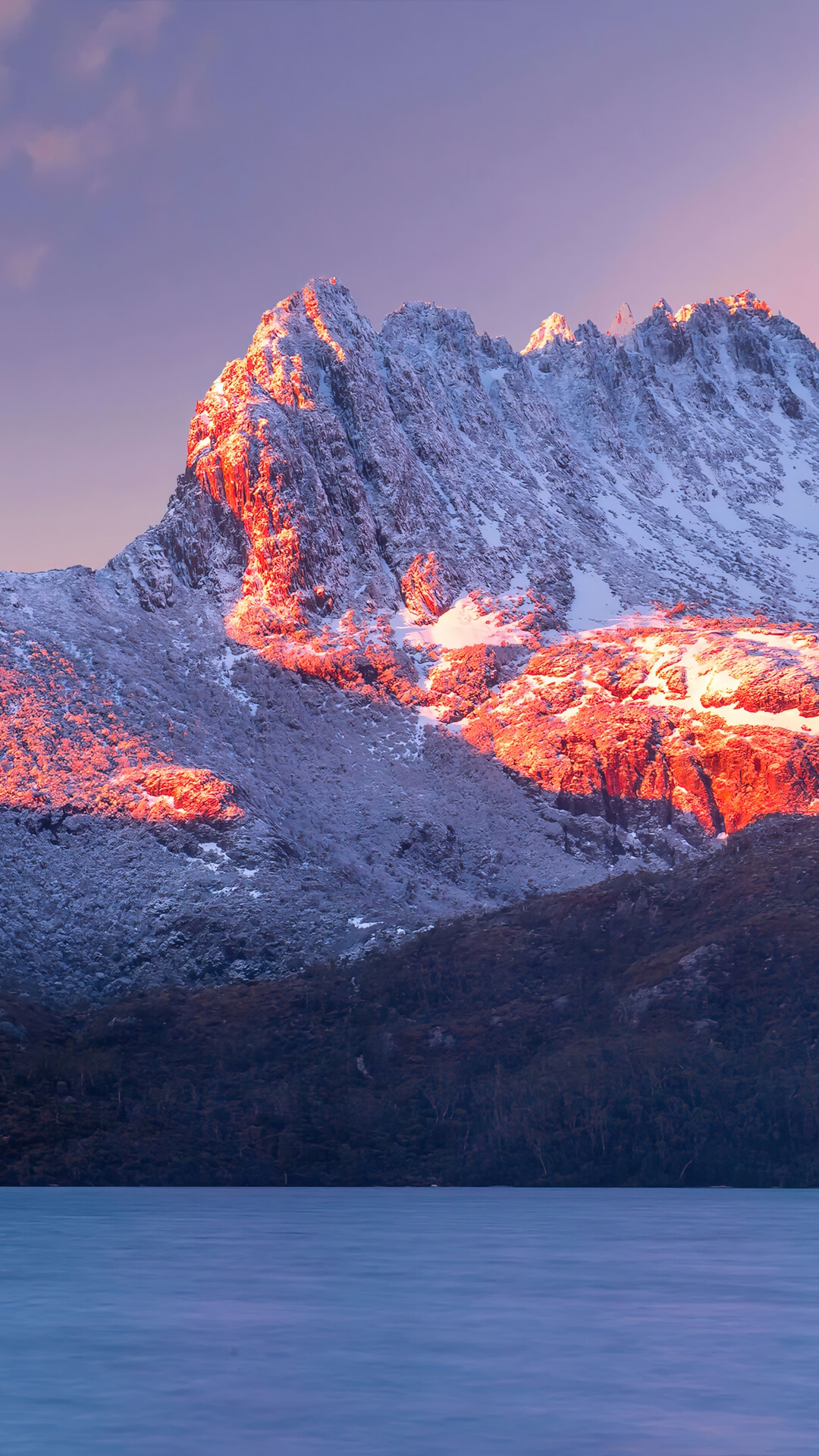 Snow-covered mountain peak at sunrise over a lake HD Phone Wallpaper