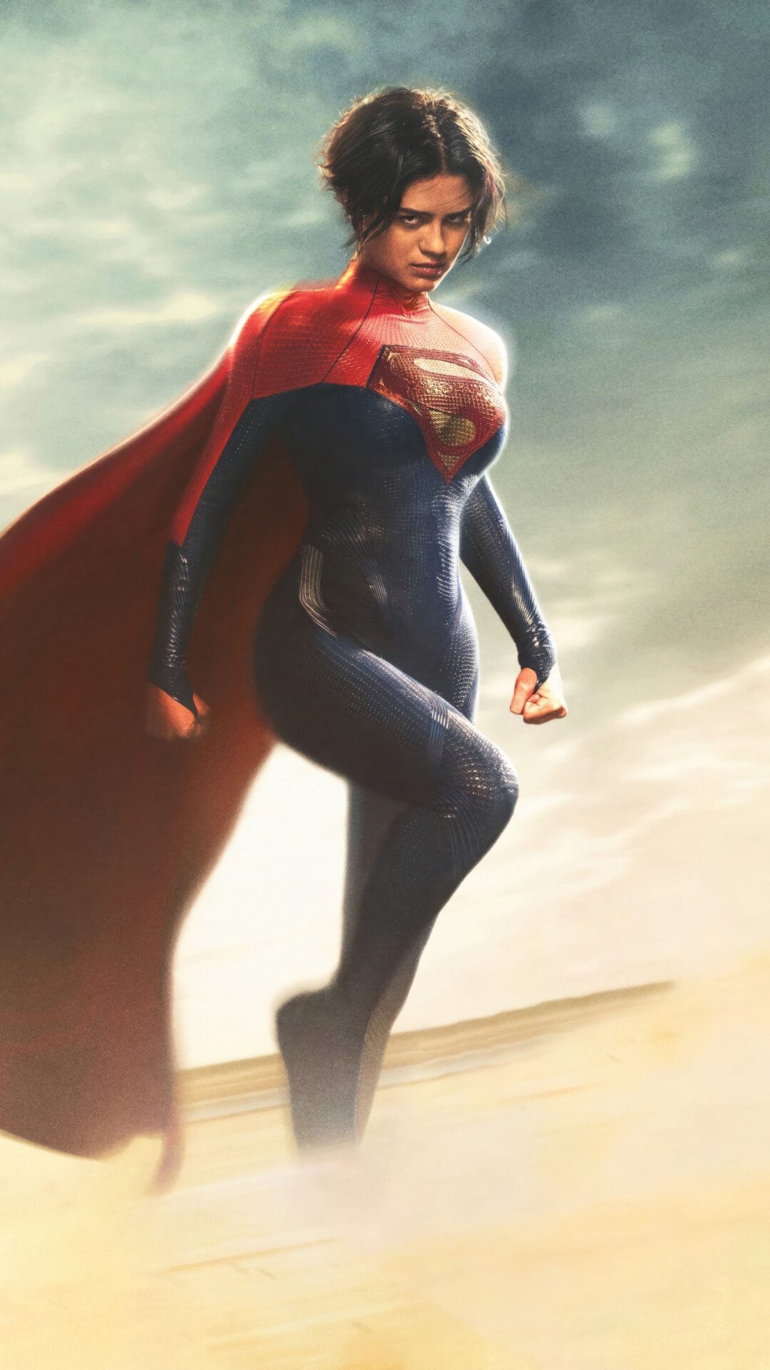 Supergirl in a red and blue suit with a red cape HD Phone Wallpaper