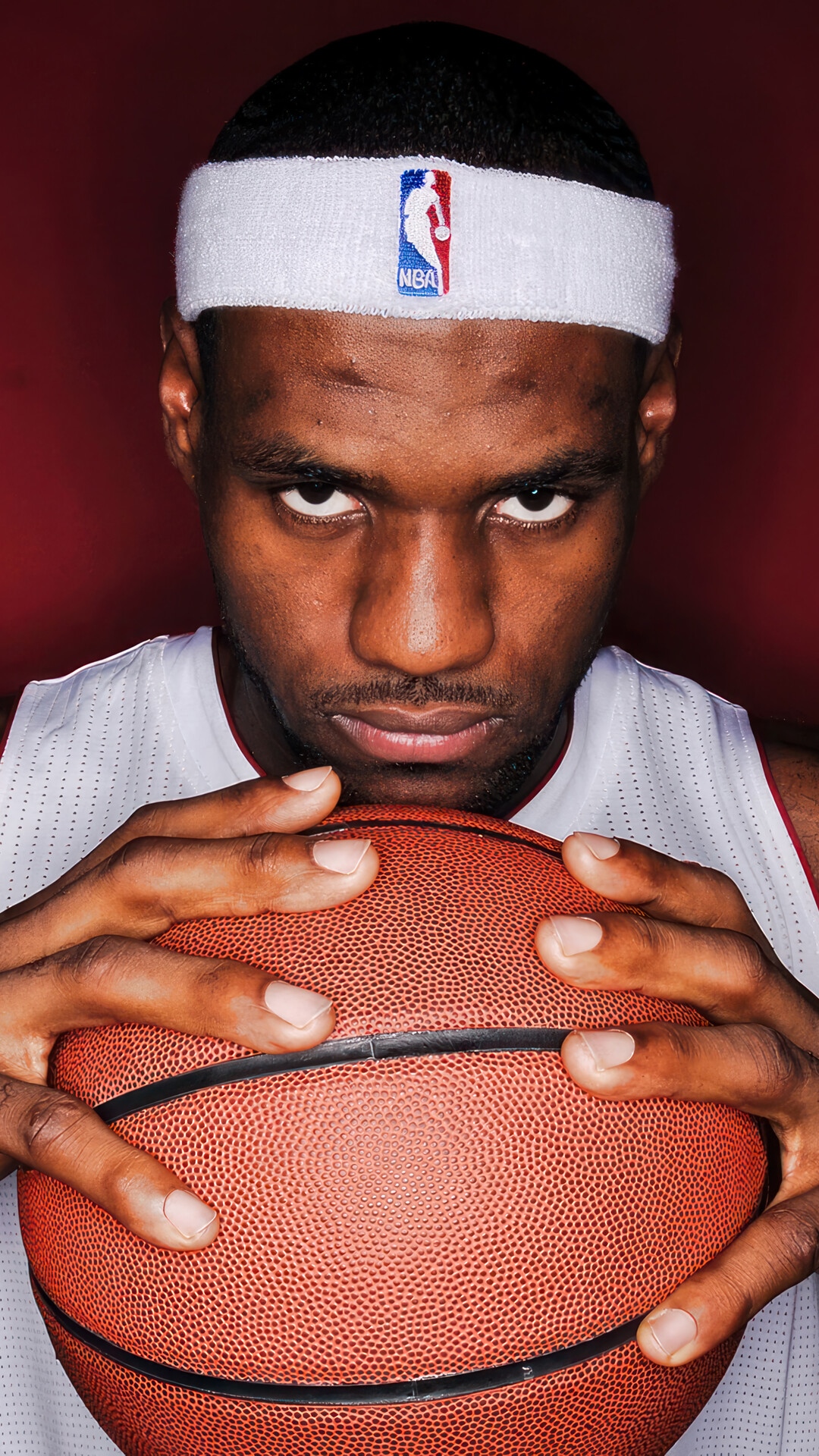 LeBron James holding a basketball with NBA headband HD Phone Wallpaper