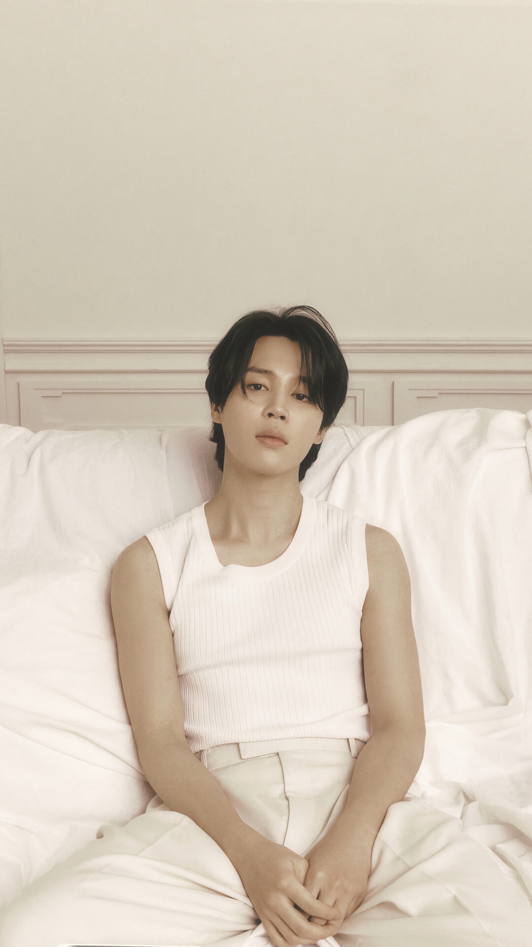Jimin of BTS sitting on a bed HD Phone Wallpaper