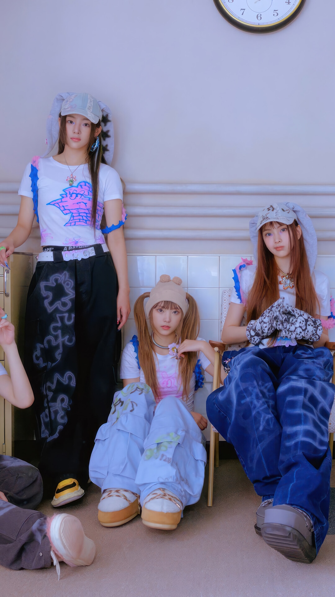 NewJeans members posing in stylish outfits HD Phone Wallpaper