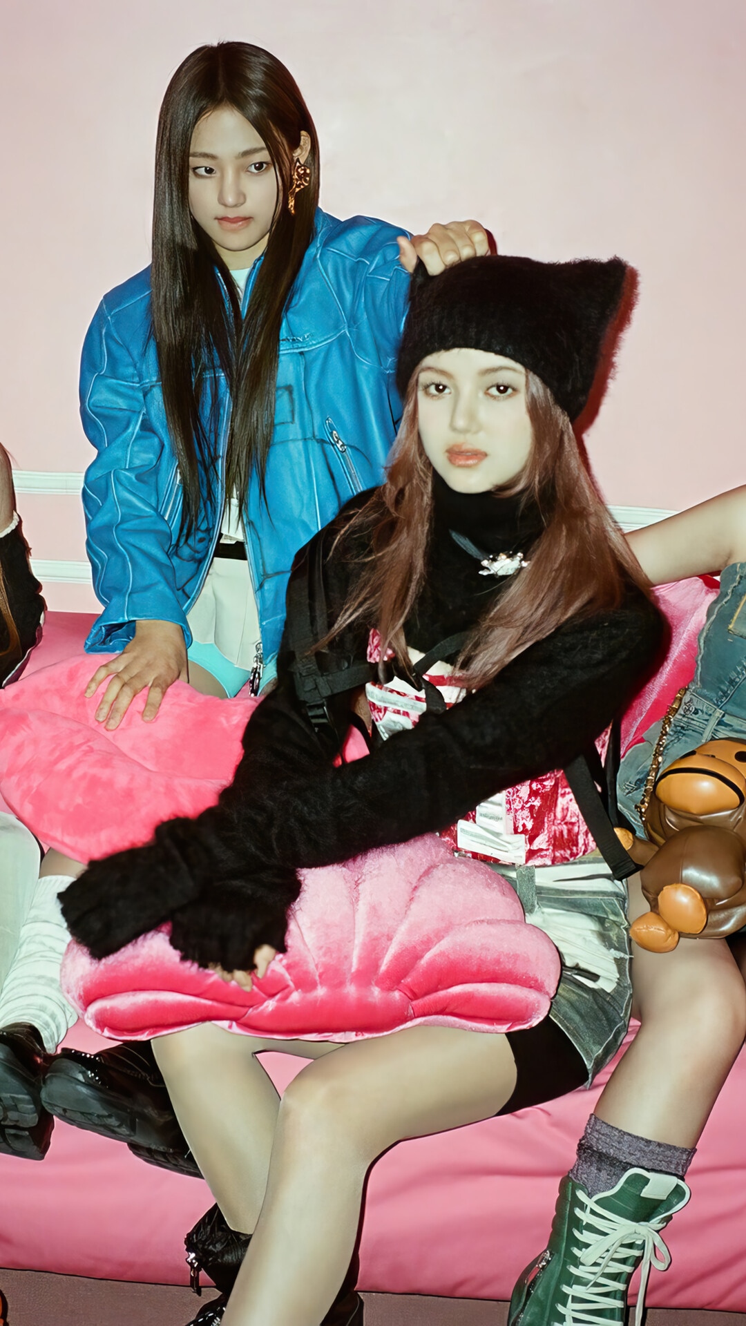 NewJeans members posing on a pink couch HD Phone Wallpaper