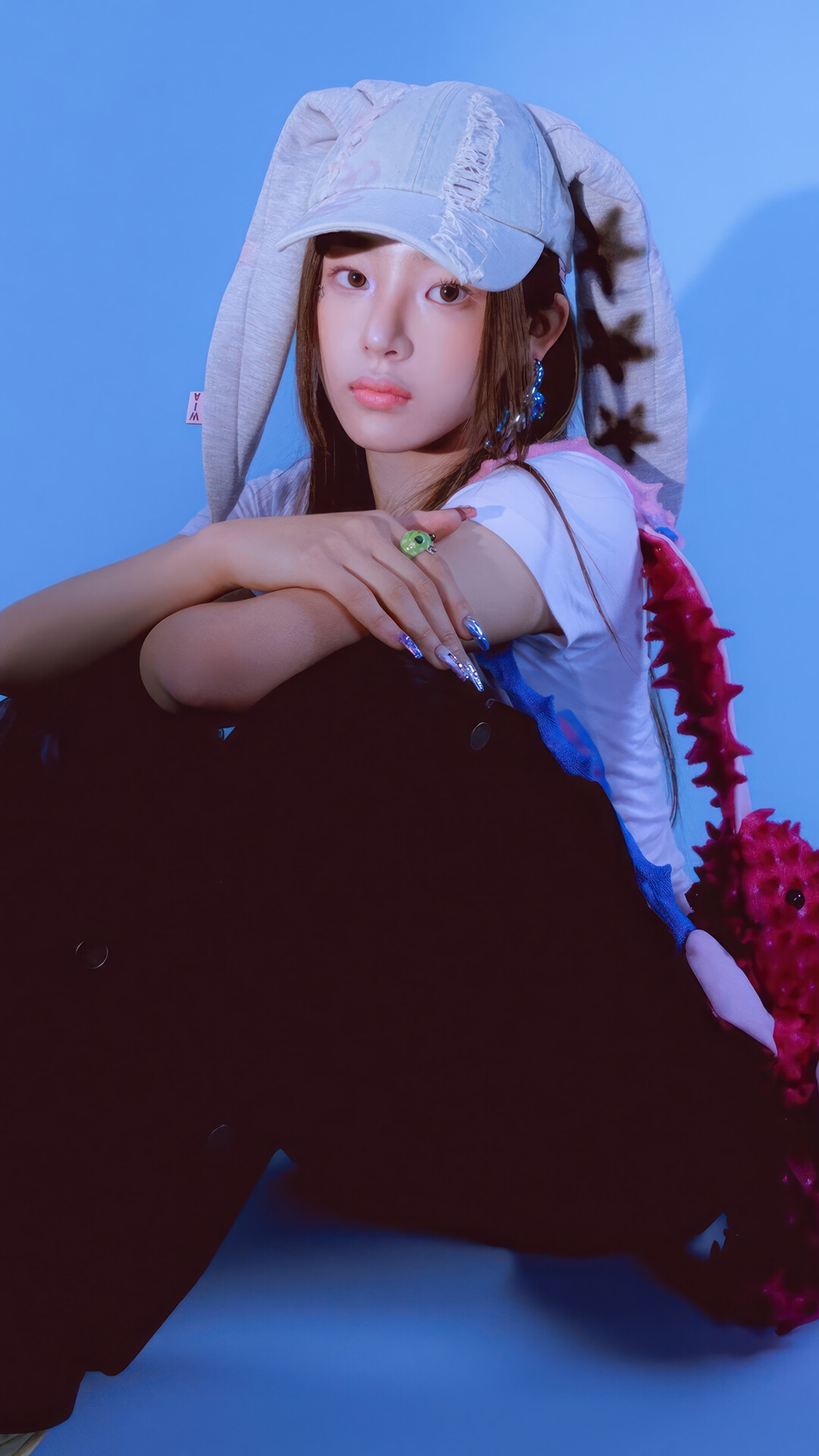 Minji from NewJeans wearing a bunny hat HD Phone Wallpaper