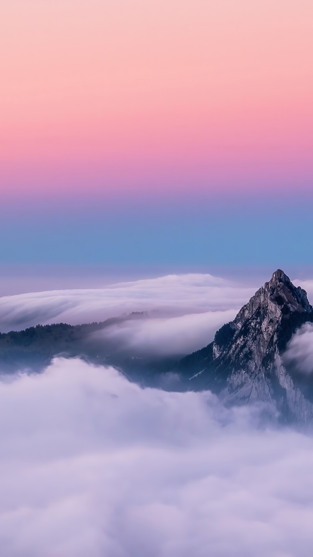 Mountain peak above a sea of clouds at sunset HD Phone Wallpaper