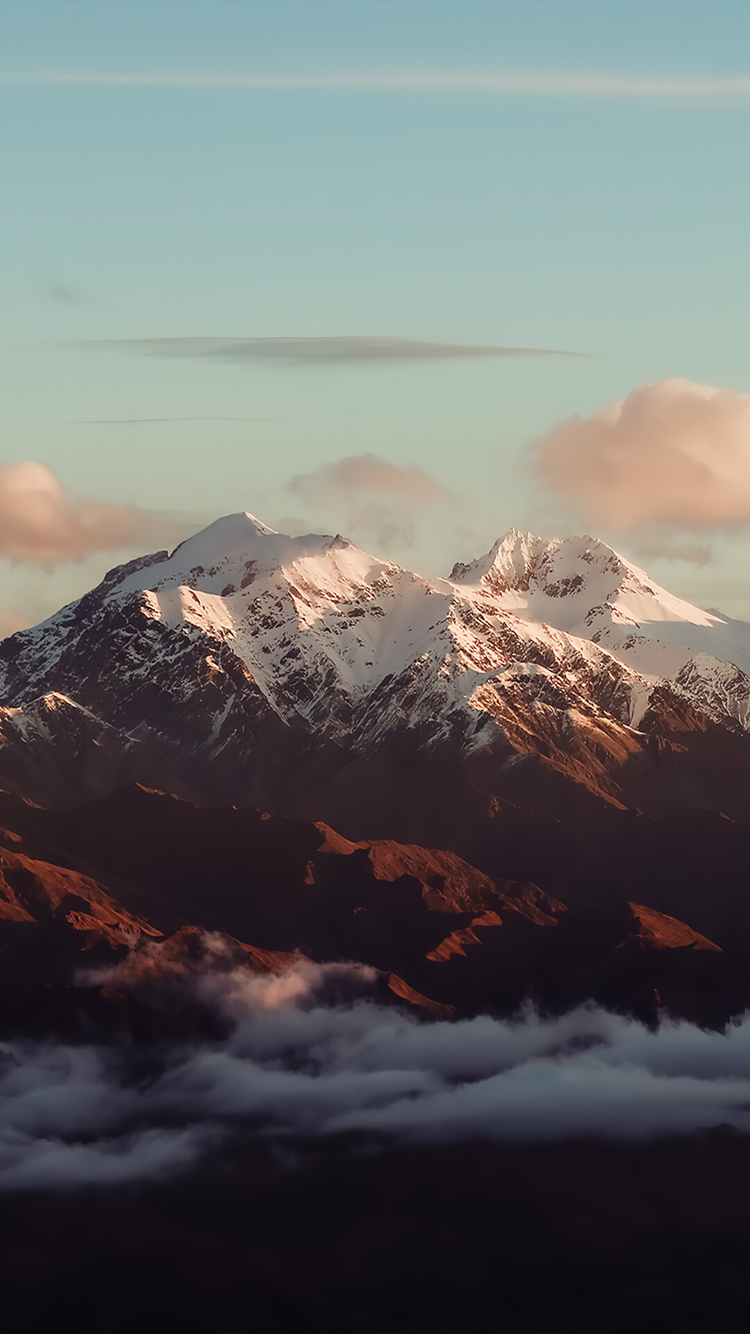 Snow-capped mountains above clouds at sunset HD Phone Wallpaper