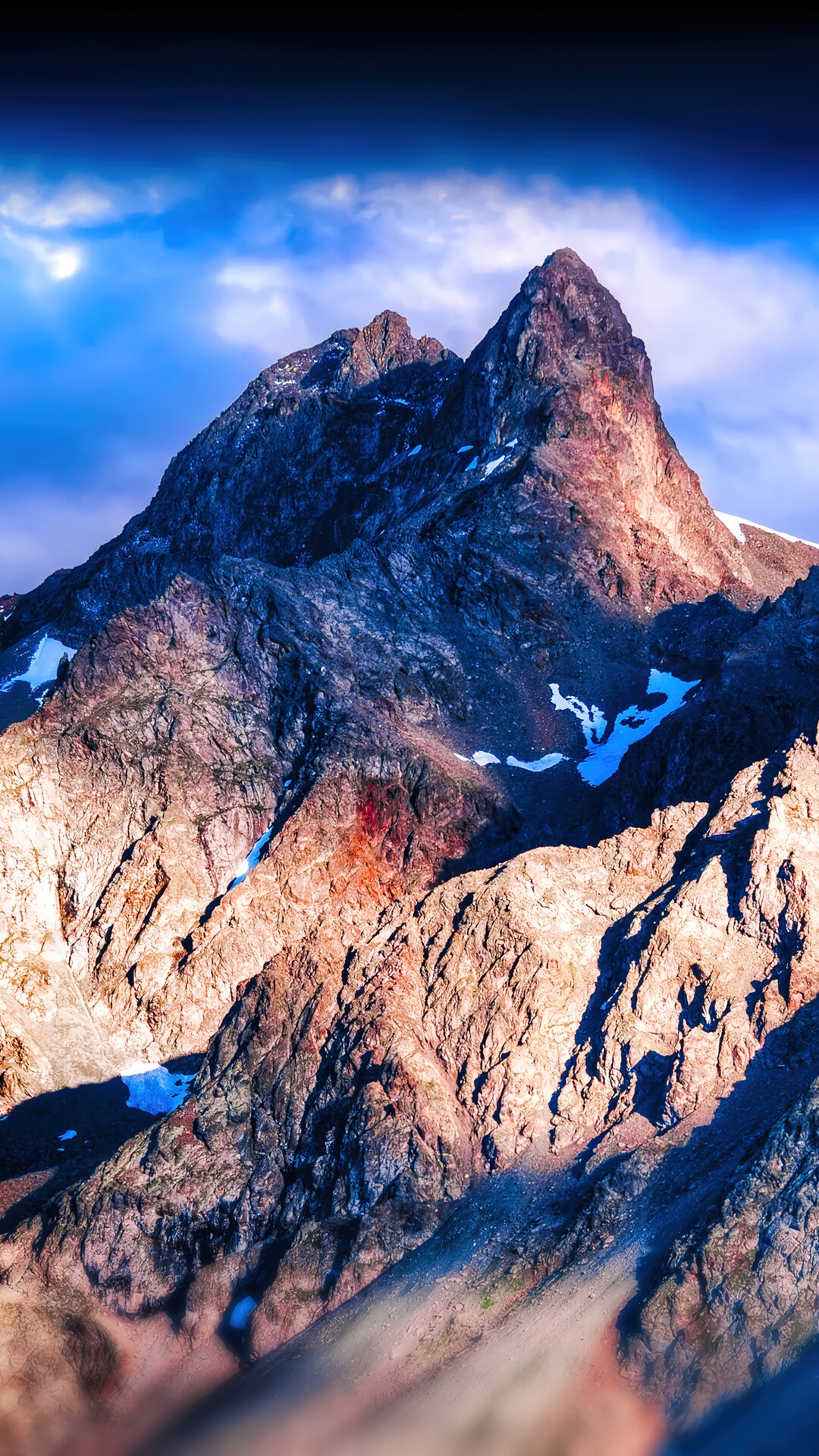 Mountain peaks under a dramatic sky HD Phone Wallpaper
