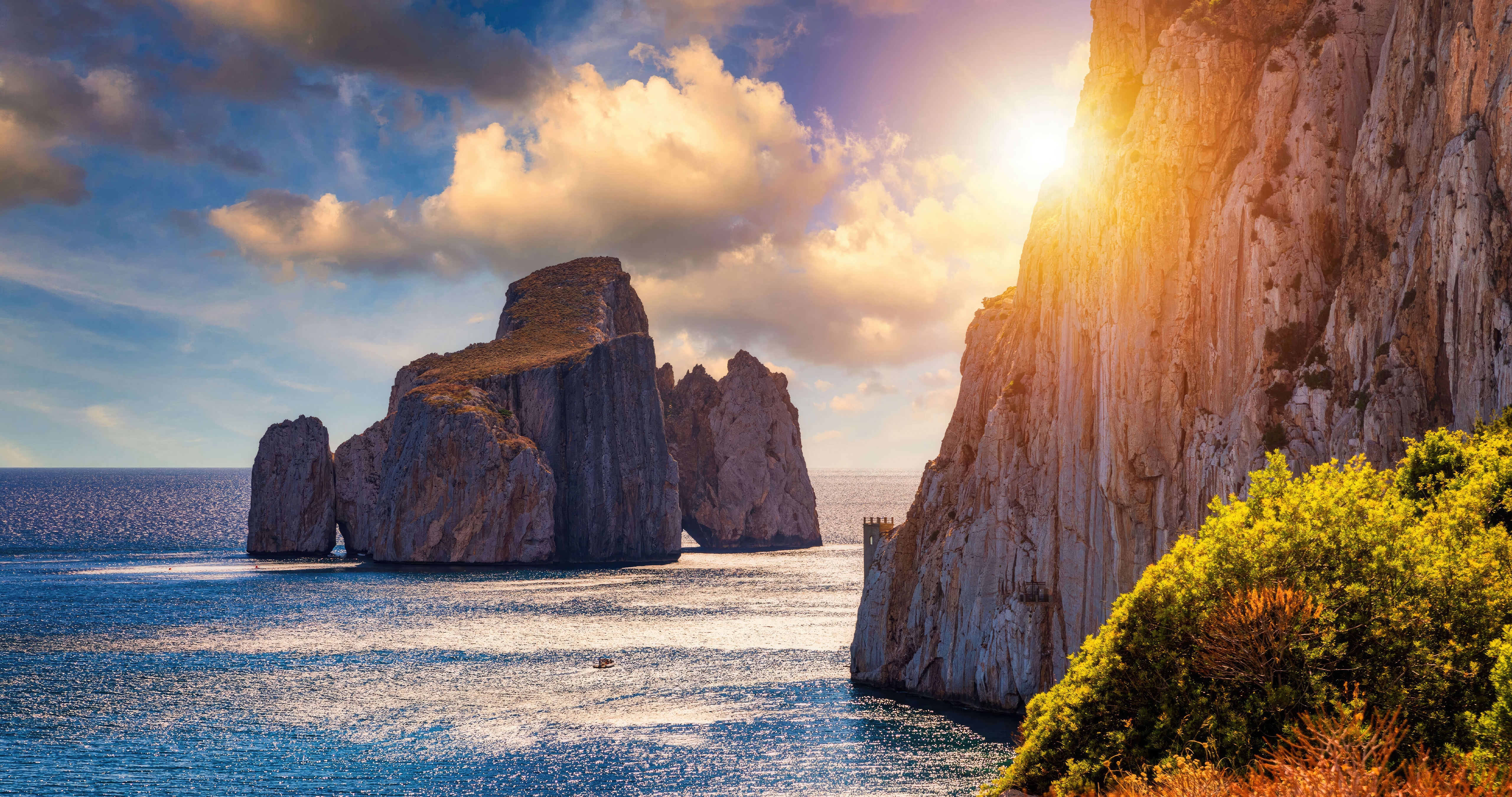 Rocky sea stacks at sunset with sun flare HD Wallpaper