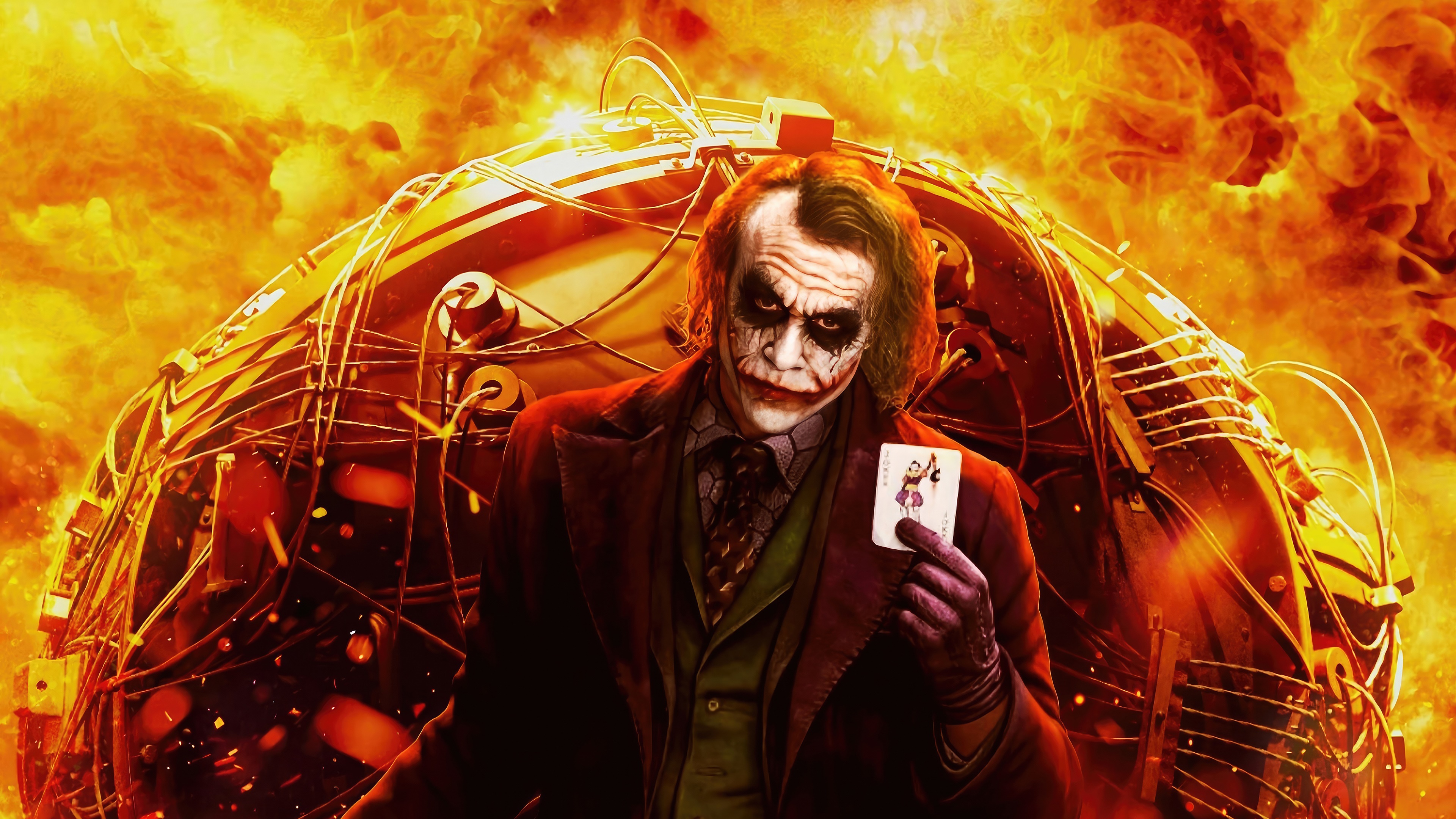 The Joker holding a playing card in front of a bomb HD Wallpaper