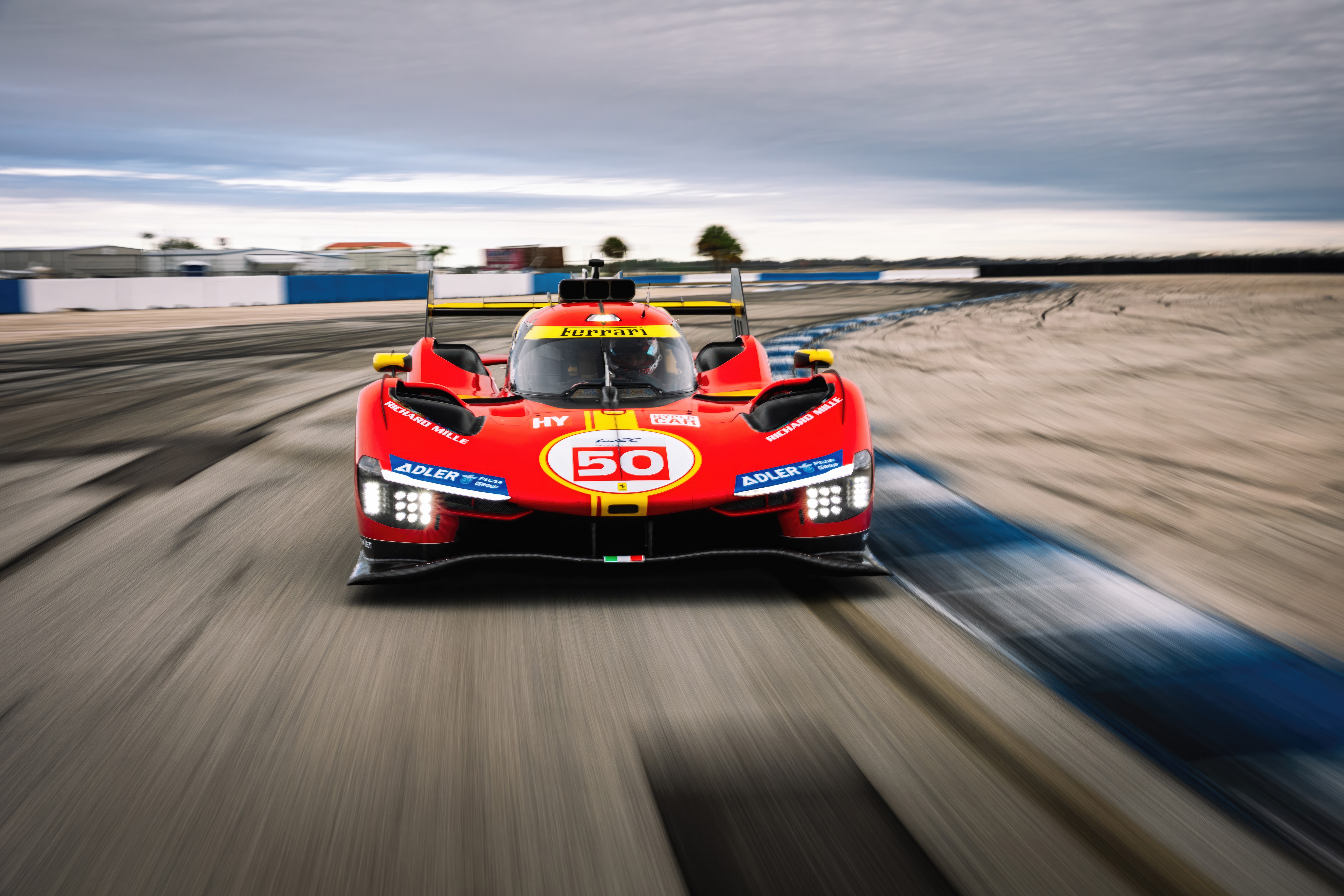 Ferrari 499P racing car on track HD Wallpaper