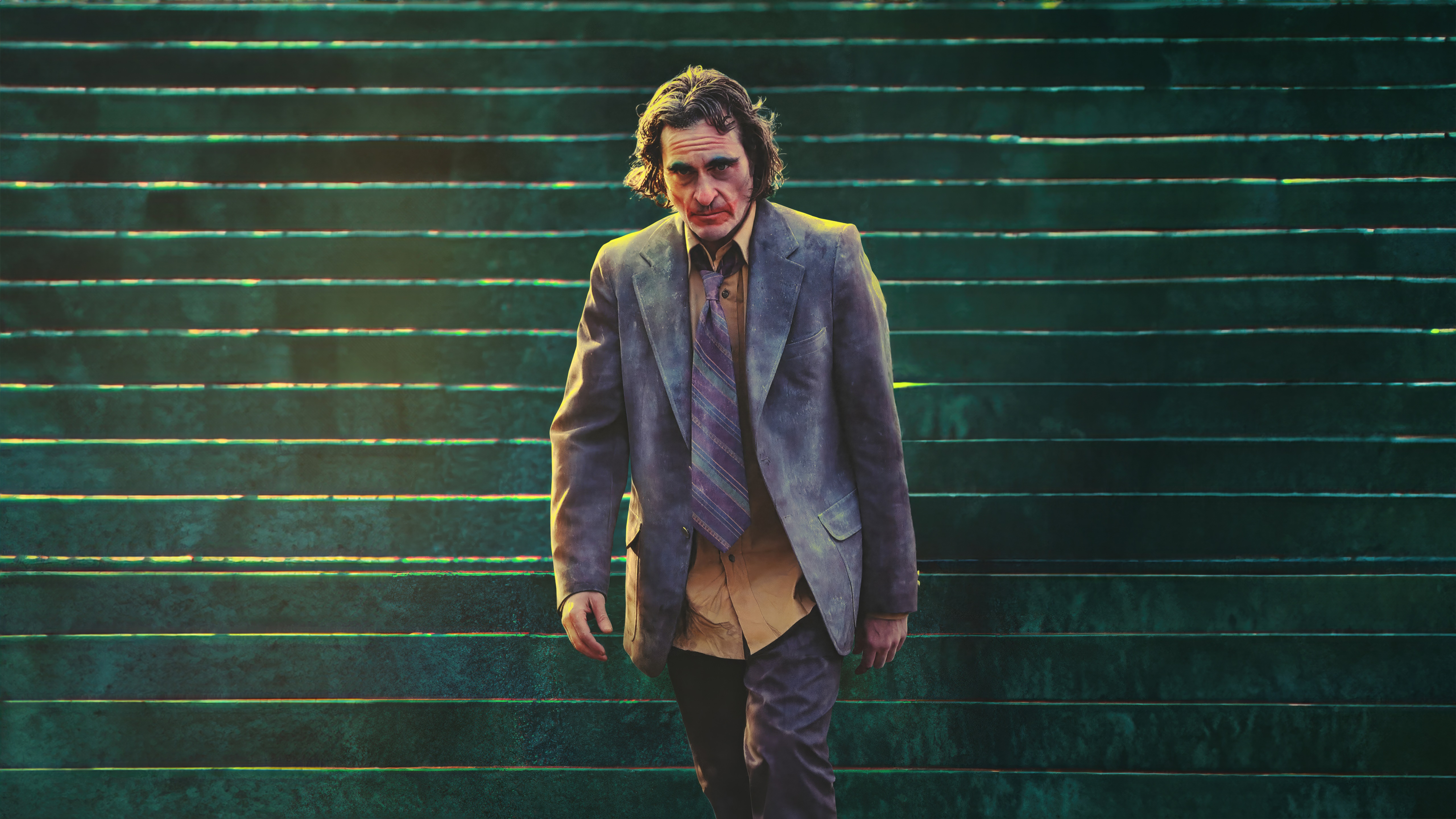 Joaquin Phoenix as Joker walking down green stairs HD Wallpaper
