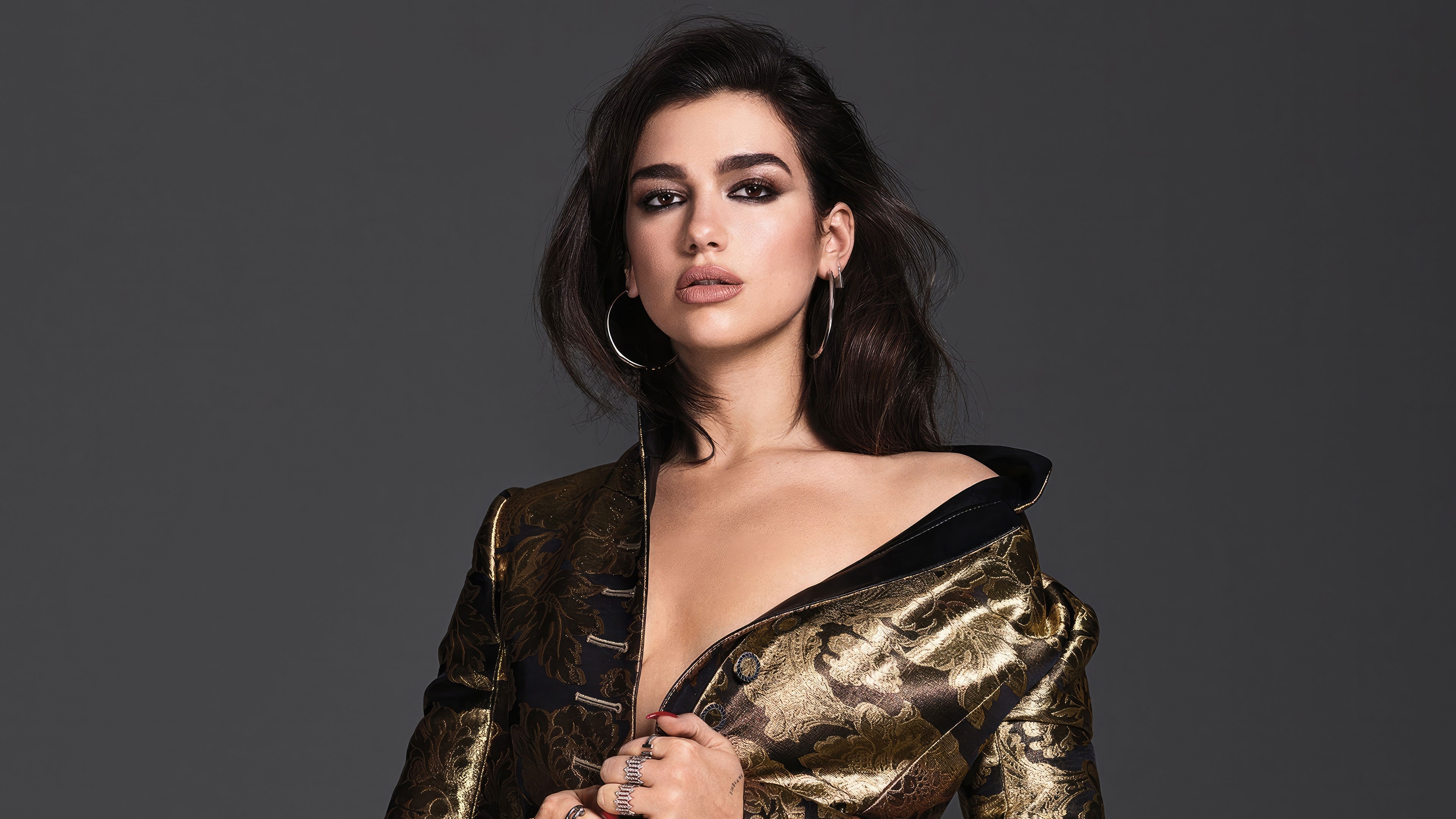 Dua Lipa in a gold and black jacket HD Wallpaper