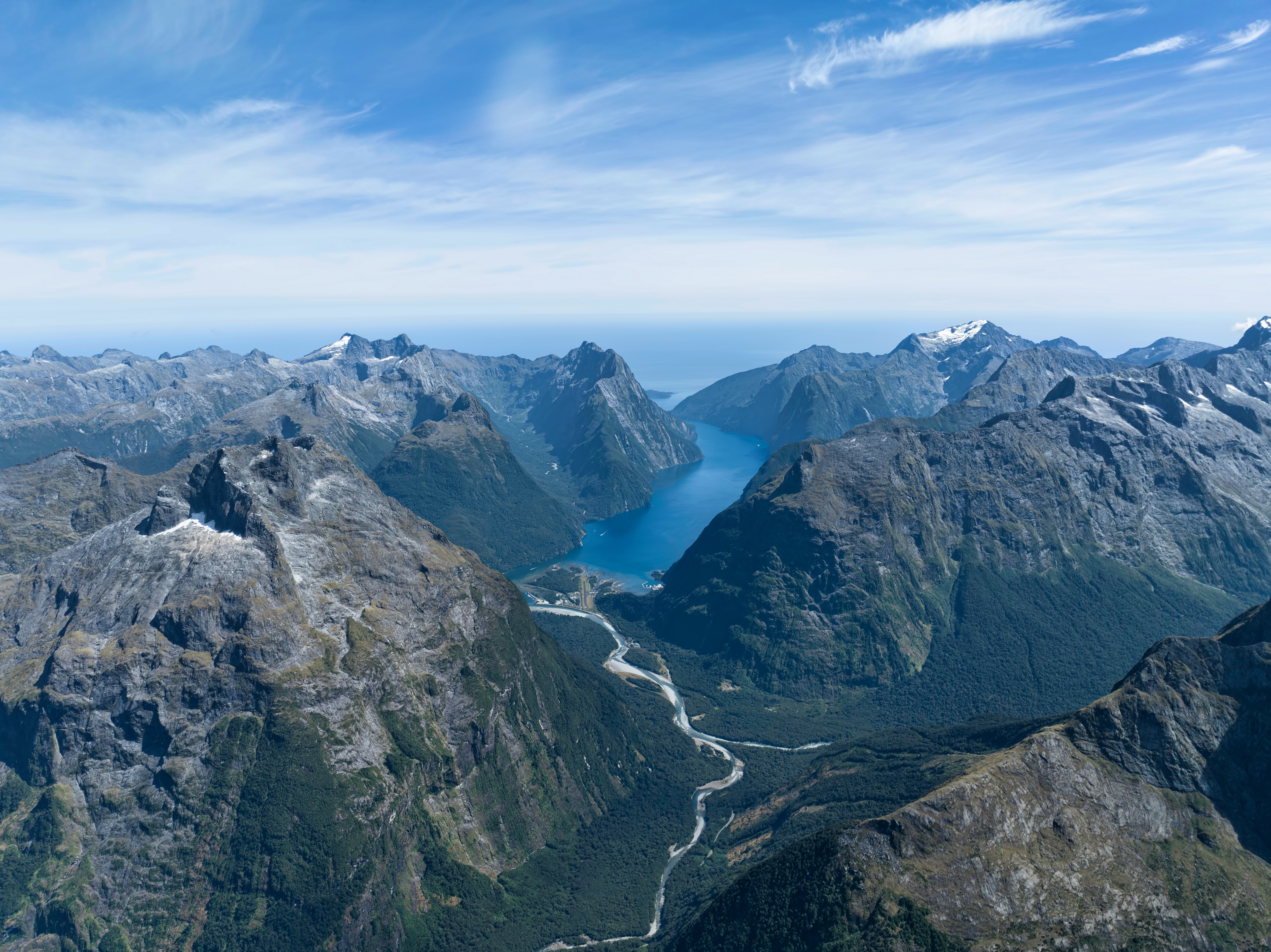 Aerial view of mountains and a blue lake in New Zealand HD Wallpaper